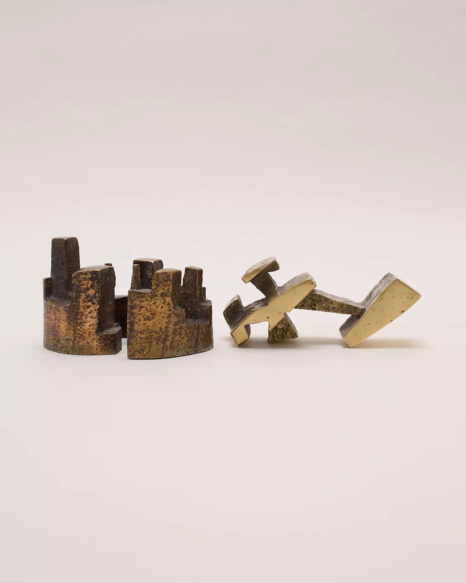 Pair of bronze geometric sculptures on a light gray background- available  to buy on the-salon.com. SALON curates the finest , unique, handmade pieces from the interior industry's best makers and brands. Shop luxury furniture, lighting, rugs, art, antiques and vintage pieces and accessories from SALON interior designed rooms.