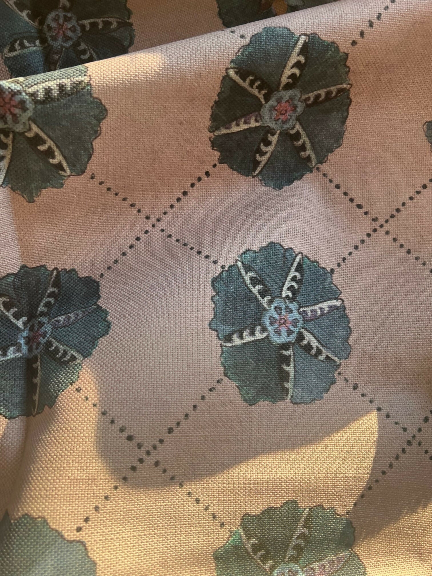 A piece of suzani fabric with floral patterns in blues, greens and multicolor hues,  available  to buy on the-salon.com. SALON curates the finest , unique, handmade pieces from the interior industry's best makers and brands. Shop luxury furniture, lighting, rugs, art, antiques and vintage pieces and accessories from SALON interior designed rooms.