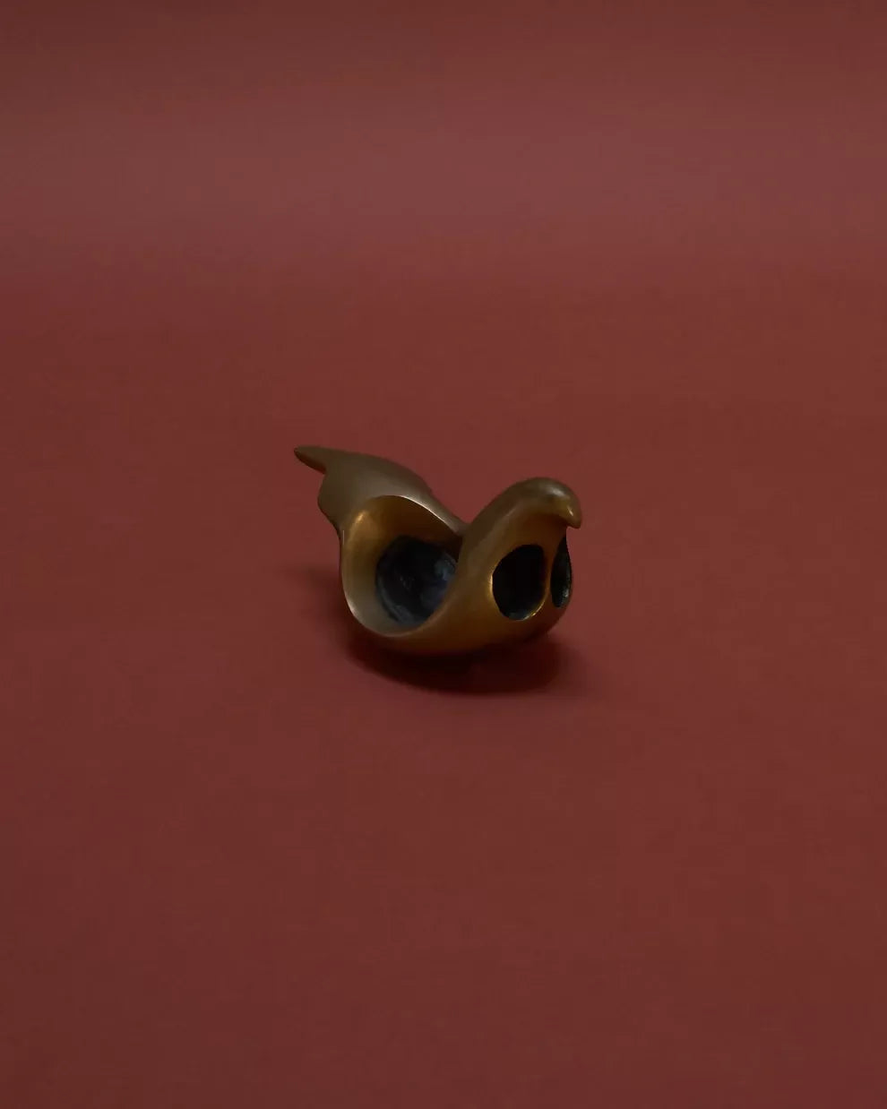 Bronze sculpture of a bird, likely a dove, with a rounded breast, placed against a red background,  available  to buy on the-salon.com. SALON curates the finest , unique, handmade pieces from the interior industry's best makers and brands. Shop luxury furniture, lighting, rugs, art, antiques and vintage pieces and accessories from SALON interior designed rooms.