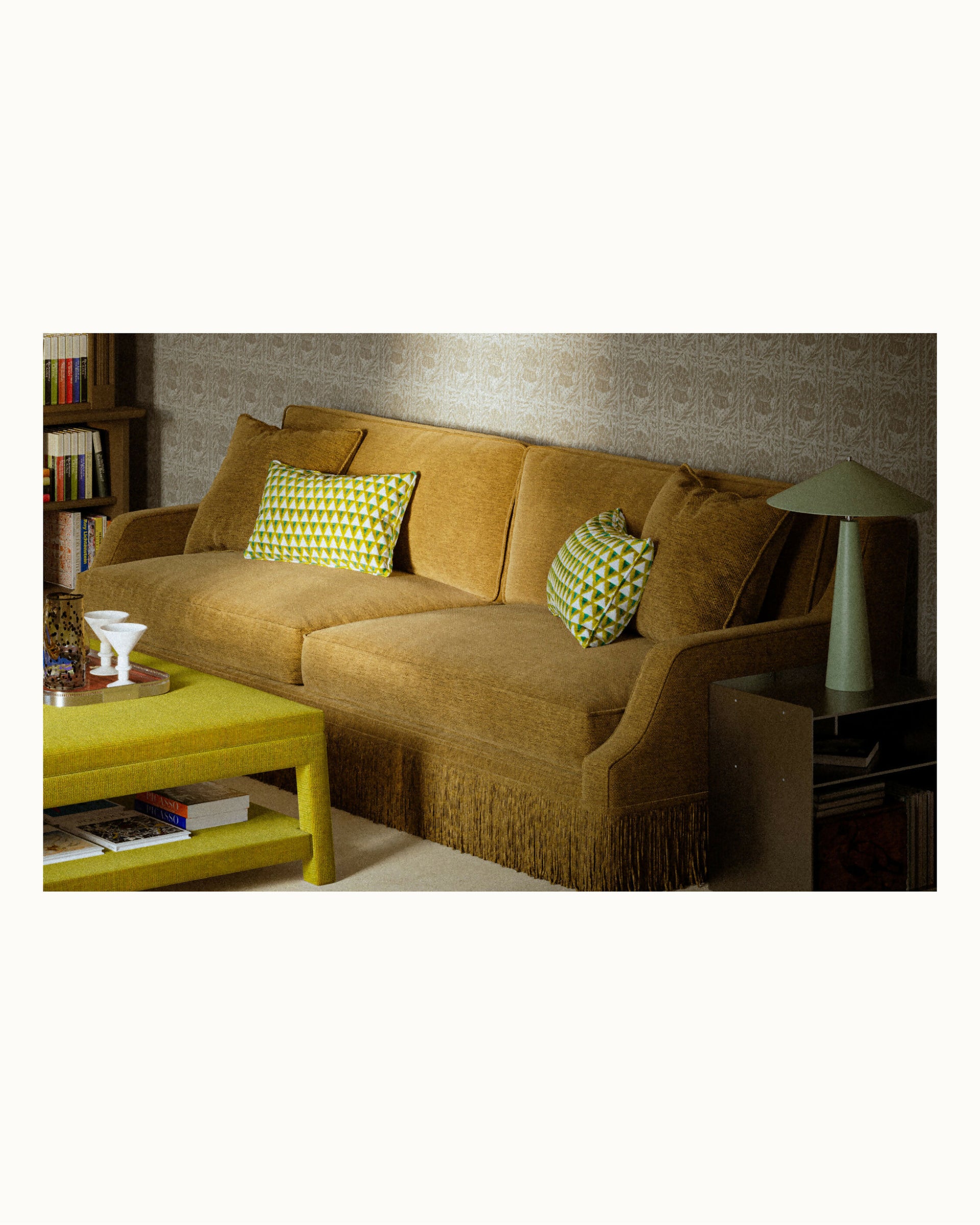 Brown sectional sofa with green cushions in a living room setting,  available  to buy on the-salon.com. SALON curates the finest , unique, handmade pieces from the interior industry's best makers and brands. Shop luxury furniture, lighting, rugs, art, antiques and vintage pieces and accessories from SALON interior designed rooms.