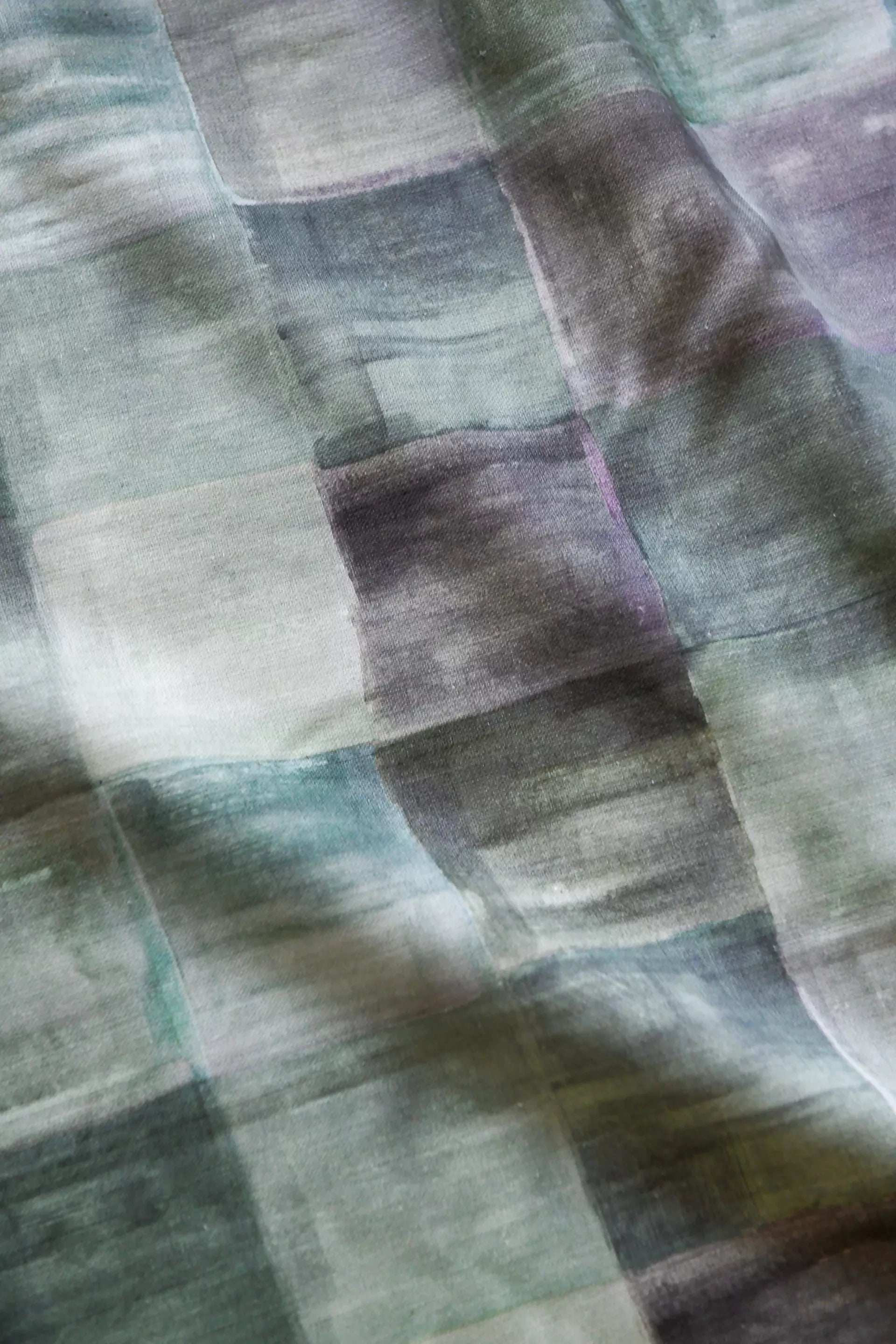 A close-up of a plaid fabric featuring a pattern of various solid colors, including blue, pink, green, and yellow,  available  to buy on the-salon.com. SALON curates the finest , unique, handmade pieces from the interior industry's best makers and brands. Shop luxury furniture, lighting, rugs, art, antiques and vintage pieces and accessories from SALON interior designed rooms.