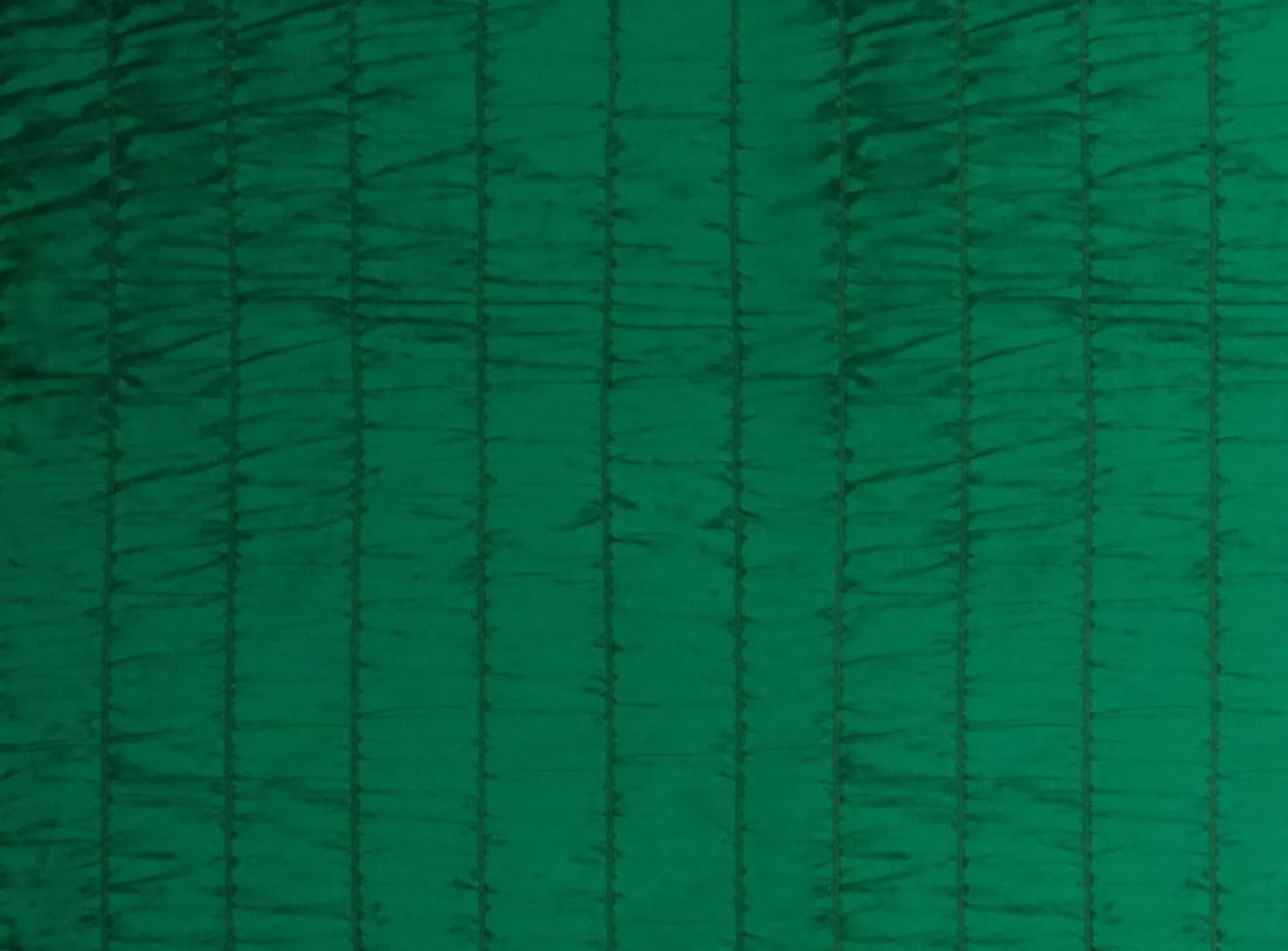 Close-up of a green fabric with a textured design, likely silk, used as a backdrop for painting or creative purposes,  available  to buy on the-salon.com. SALON curates the finest , unique, handmade pieces from the interior industry's best makers and brands. Shop luxury furniture, lighting, rugs, art, antiques and vintage pieces and accessories from SALON interior designed rooms.