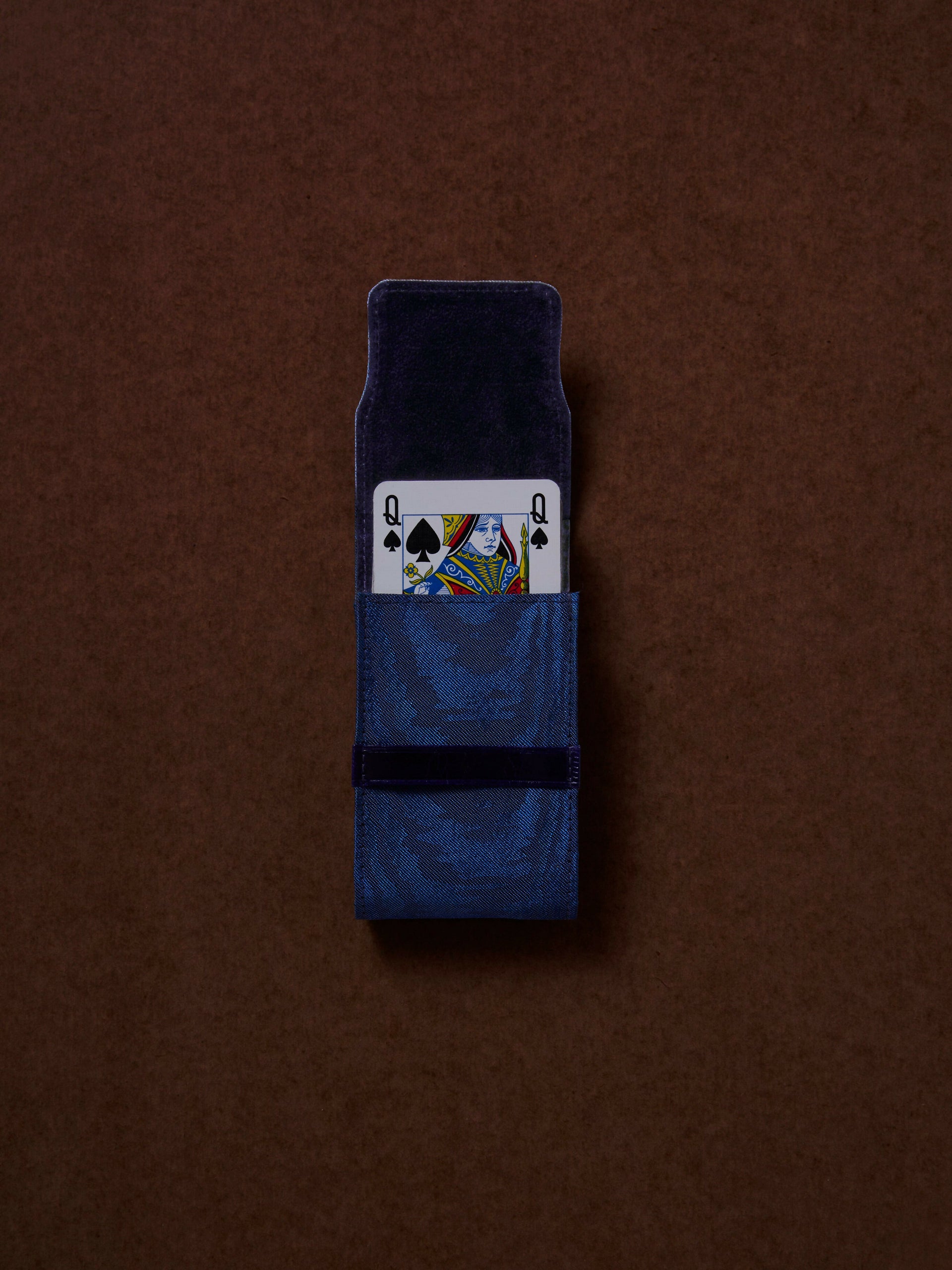 Blue box with a playing card design on a brown background,  available  to buy on the-salon.com. SALON curates the finest , unique, handmade pieces from the interior industry's best makers and brands. Shop luxury furniture, lighting, rugs, art, antiques and vintage pieces and accessories from SALON interior designed rooms.