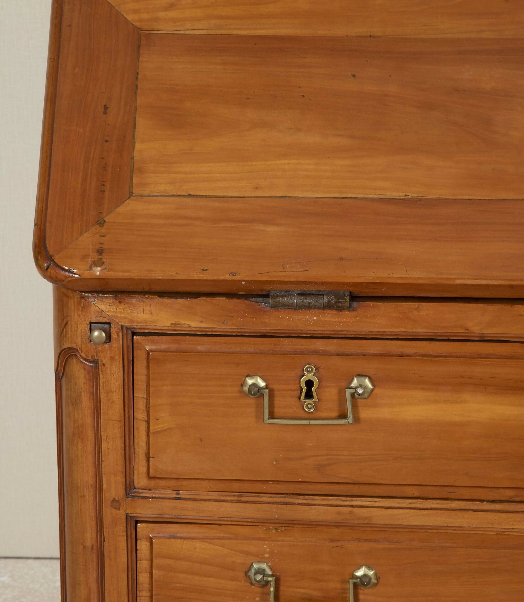 Close-up of a wooden cabinet with a lock and handle on a plain background,  available  to buy on the-salon.com. SALON curates the finest , unique, handmade pieces from the interior industry's best makers and brands. Shop luxury furniture, lighting, rugs, art, antiques and vintage pieces and accessories from SALON interior designed rooms.