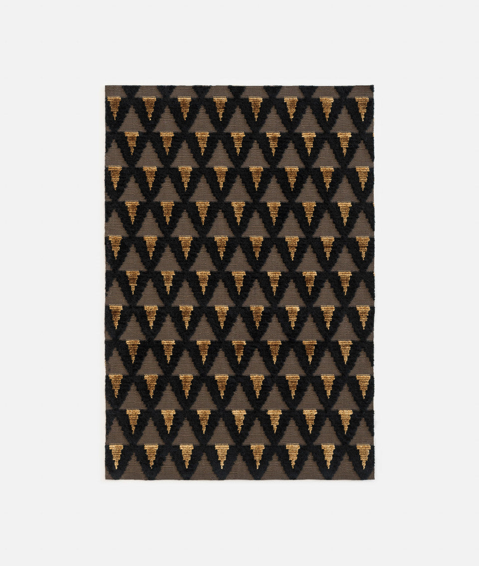 Patterned rug with geometric design on a plain background,available  to buy on the-salon.com. SALON curates the finest , unique, handmade pieces from the interior industry's best makers and brands. Shop luxury furniture, lighting, rugs, art, antiques and vintage pieces and accessories from SALON interior designed rooms
