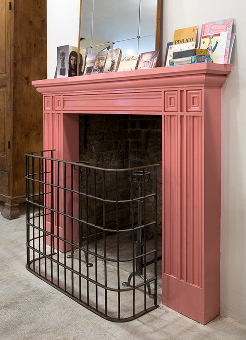 A neo-classical style red wooden fireplace with a black metal guard, designed after an original rescued from Pell Wall Hall,  available  to buy on the-salon.com. SALON curates the finest , unique, handmade pieces from the interior industry's best makers and brands. Shop luxury furniture, lighting, rugs, art, antiques and vintage pieces and accessories from SALON interior designed rooms.