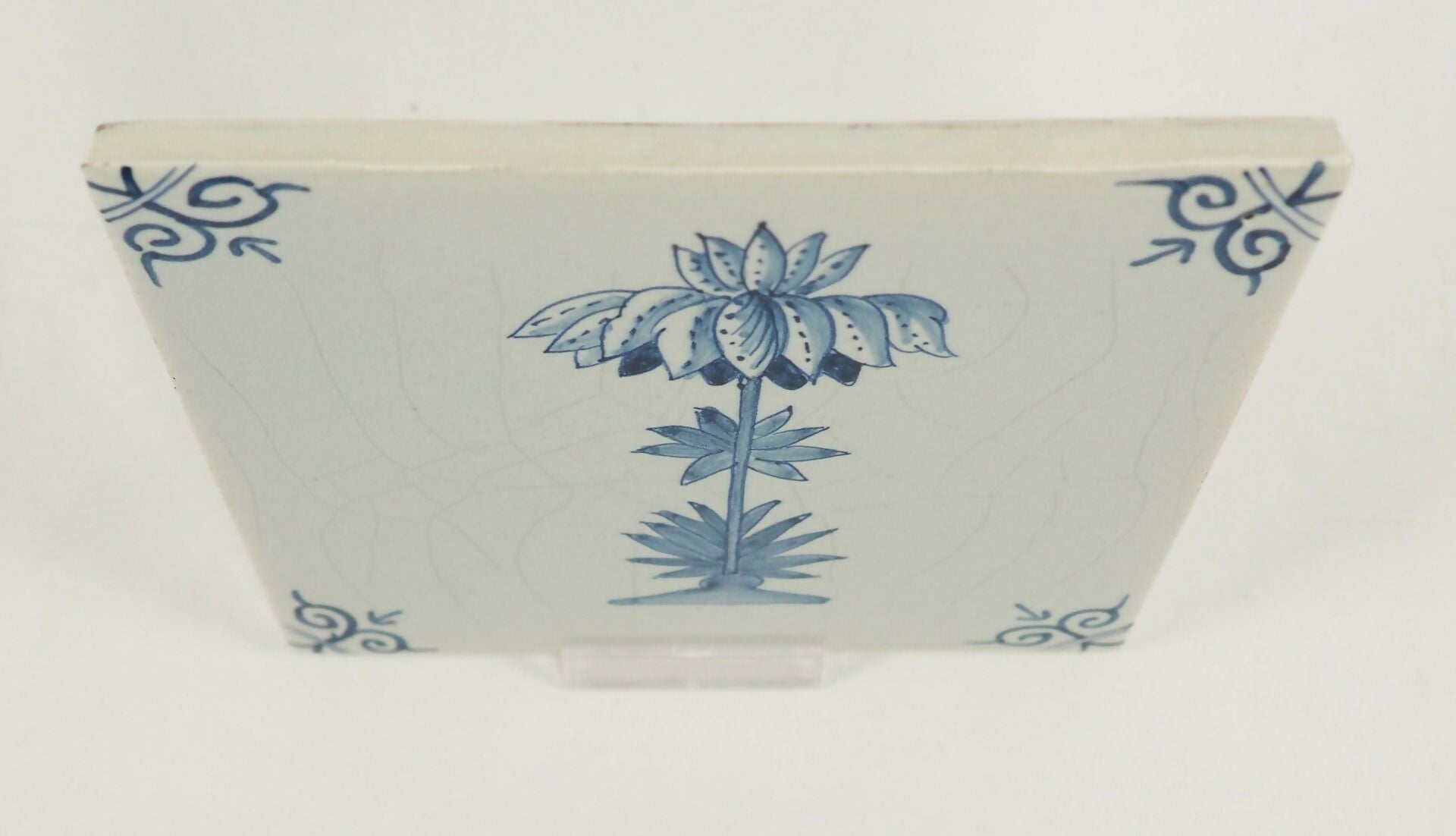 Rectangular ceramic tile with blue floral design on a white background,  available  to buy on the-salon.com. SALON curates the finest , unique, handmade pieces from the interior industry's best makers and brands. Shop luxury furniture, lighting, rugs, art, antiques and vintage pieces and accessories from SALON interior designed rooms.