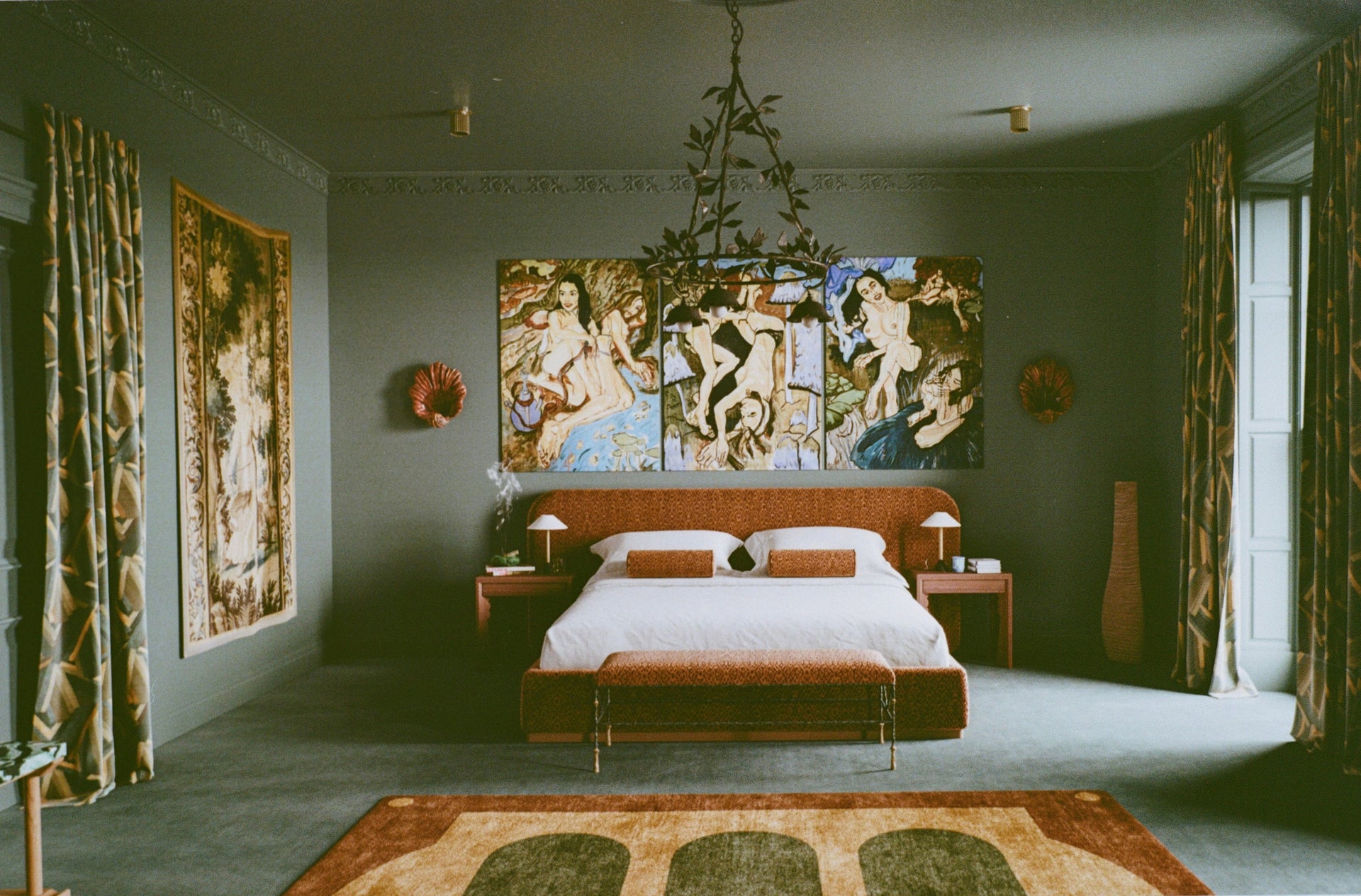 Luxurious bedroom with classical art, bed, and decorative elements.