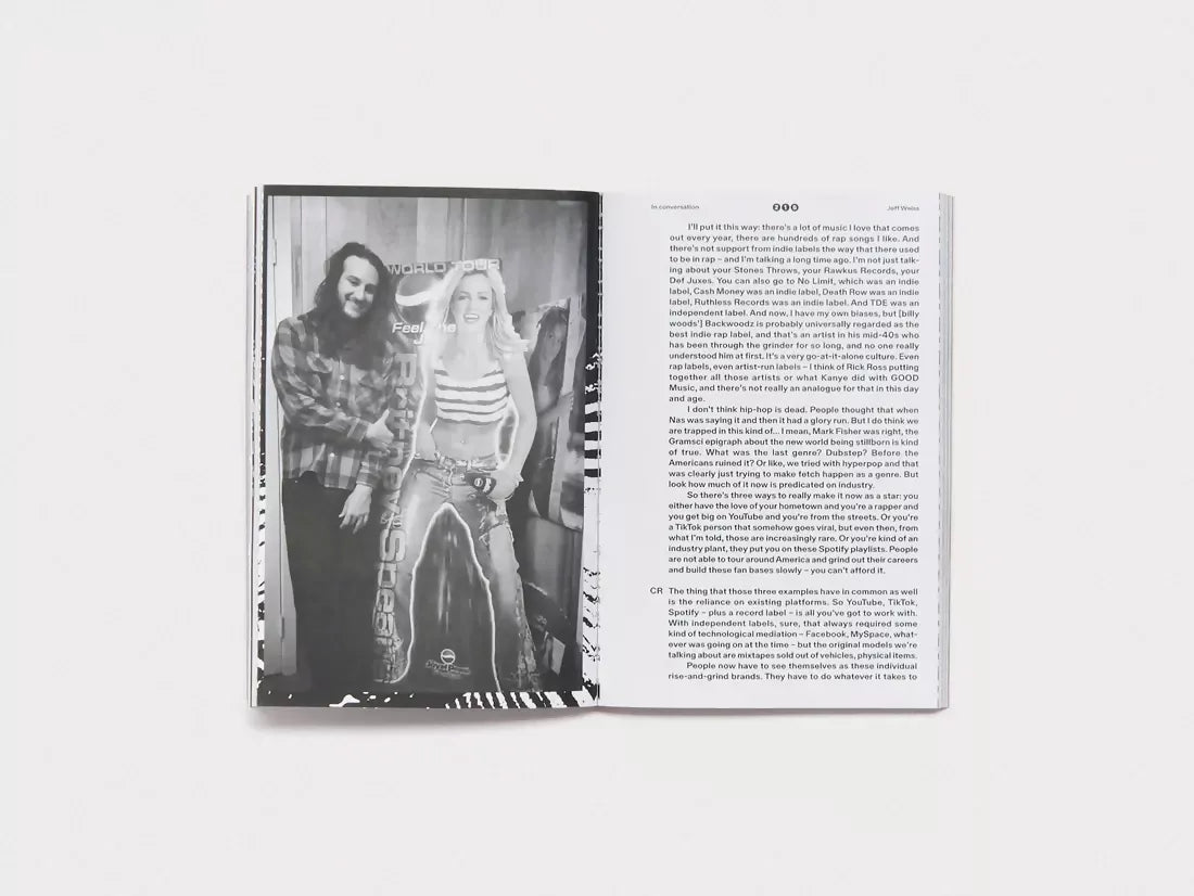 Open book, white pages, one with an image of a cardboard cutout of a musician and a man next to it, available  to buy on the-salon.com. SALON curates the finest , unique, handmade pieces from the interior industry's best makers and brands. Shop luxury furniture, lighting, rugs, art, antiques and vintage pieces and accessories from SALON interior designed rooms.