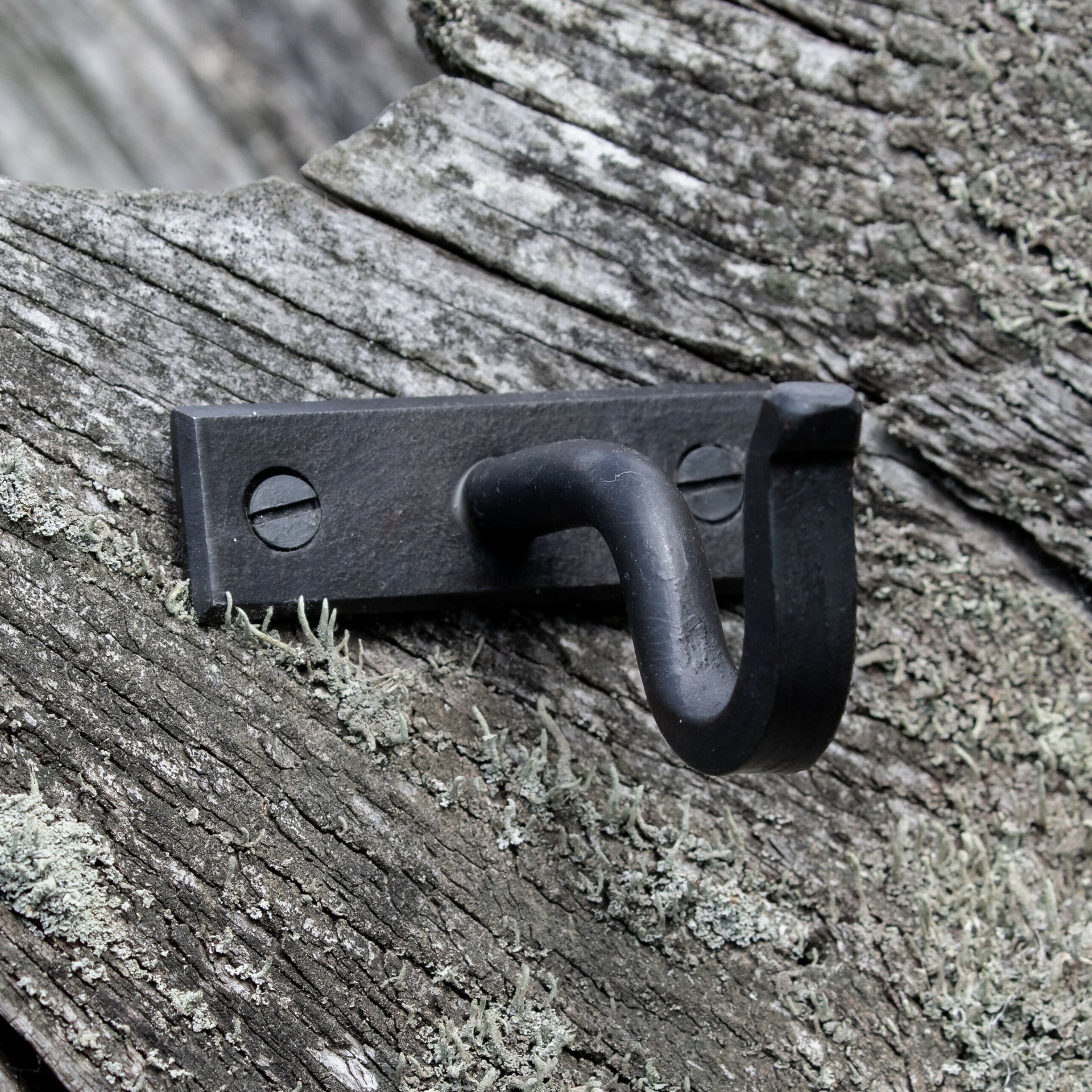 Contemporary centre black bracket, displayed on a natural wood background,  available  to buy on the-salon.com. SALON curates the finest , unique, handmade pieces from the interior industry's best makers and brands. Shop luxury furniture, lighting, rugs, art, antiques and vintage pieces and accessories from SALON interior designed rooms.