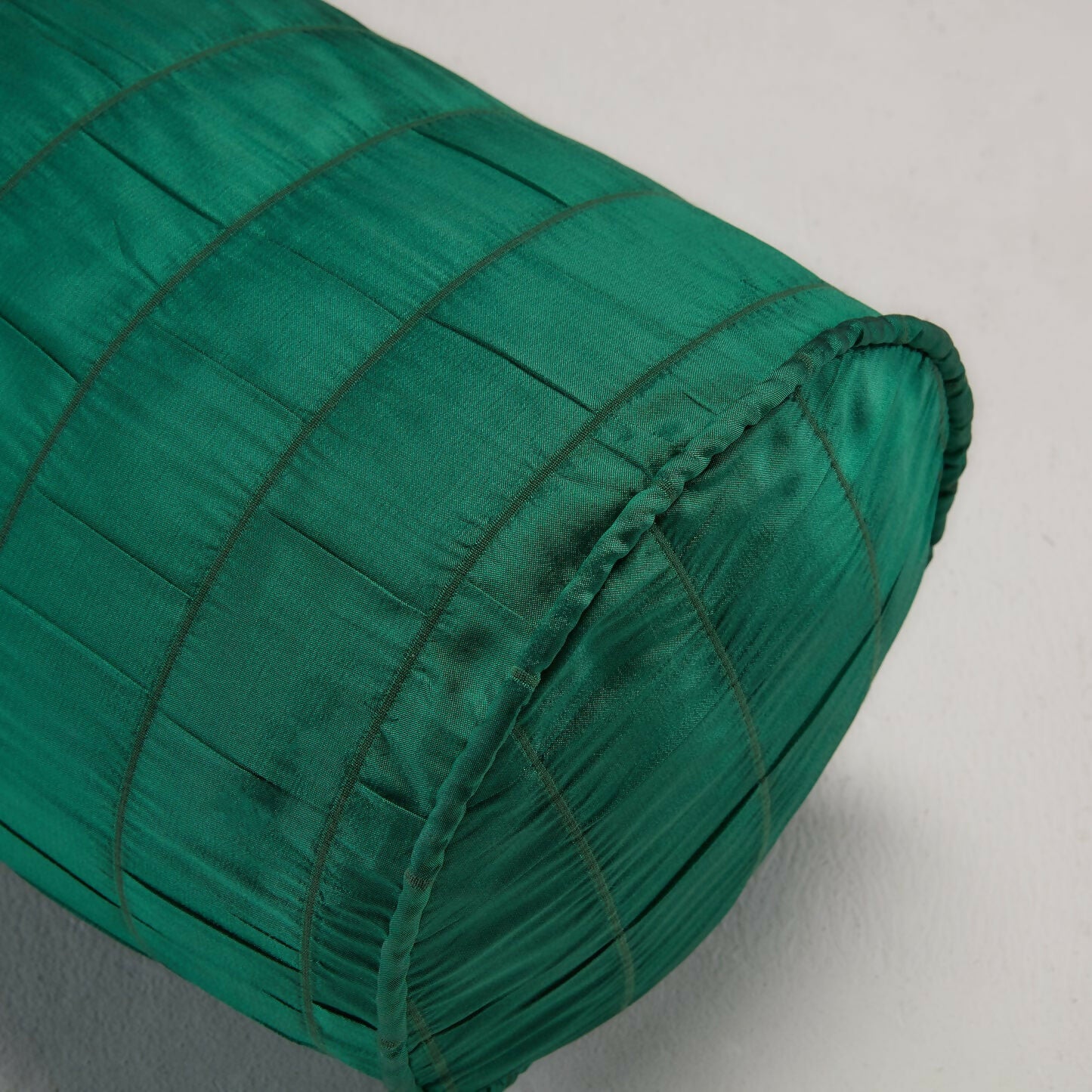 Close-up of a green fabric with a textured design, likely silk, used as a backdrop for painting or creative purposes,  available  to buy on the-salon.com. SALON curates the finest , unique, handmade pieces from the interior industry's best makers and brands. Shop luxury furniture, lighting, rugs, art, antiques and vintage pieces and accessories from SALON interior designed rooms.