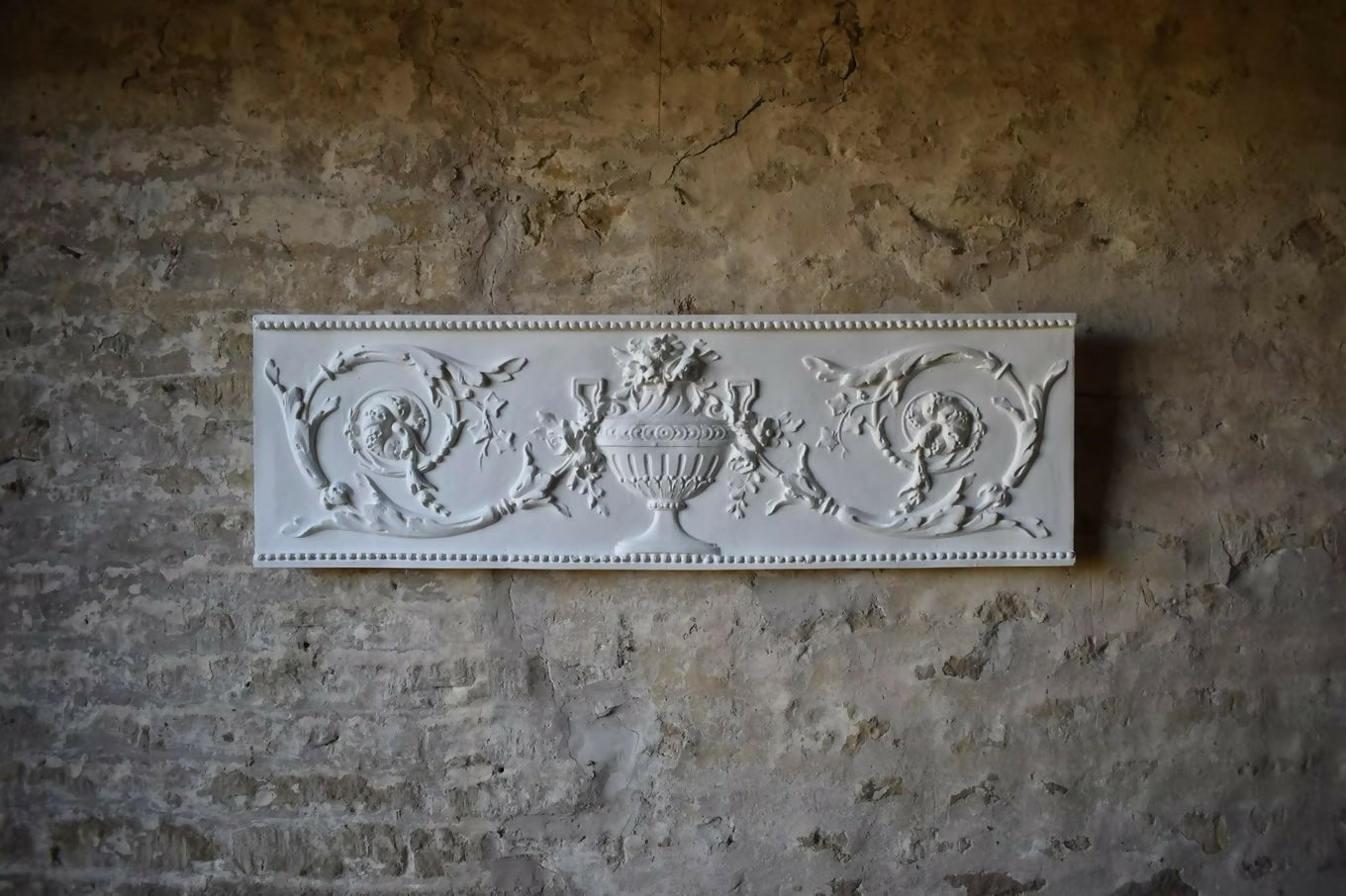 A plaster cast of an ornamental frieze with floral elements and geometric border, displayed against a textured wall, available  to buy on the-salon.com. SALON curates the finest , unique, handmade pieces from the interior industry's best makers and brands. Shop luxury furniture, lighting, rugs, art, antiques and vintage pieces and accessories from SALON interior designed rooms.