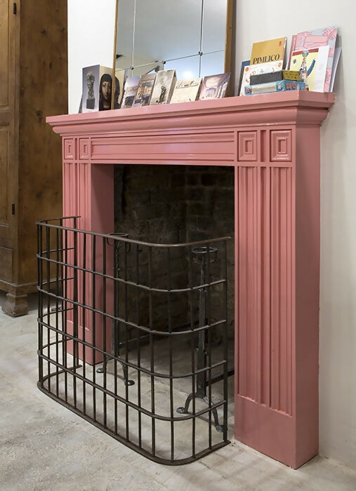 A neo-classical style fireplace made of redwood pine with a metal fire screen, set against a white background,  available  to buy on the-salon.com. SALON curates the finest , unique, handmade pieces from the interior industry's best makers and brands. Shop luxury furniture, lighting, rugs, art, antiques and vintage pieces and accessories from SALON interior designed rooms.