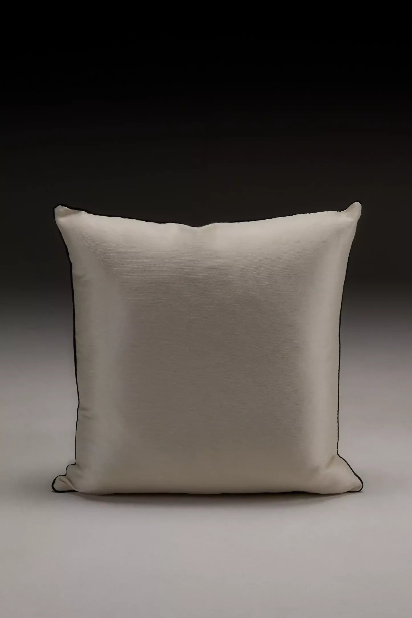 Close-up of a silk sateen fabric in a champagne colour, displaying its texture and sheen on the pillow,  available  to buy on the-salon.com. SALON curates the finest , unique, handmade pieces from the interior industry's best makers and brands. Shop luxury furniture, lighting, rugs, art, antiques and vintage pieces and accessories from SALON interior designed rooms.