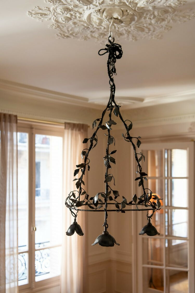 Decorative black chandelier hanging in a room with large windows and ornate ceiling, available  to buy on the-salon.com. SALON curates the finest , unique, handmade pieces from the interior industry's best makers and brands. Shop luxury furniture, lighting, rugs, art, antiques and vintage pieces and accessories from SALON interior designed rooms.