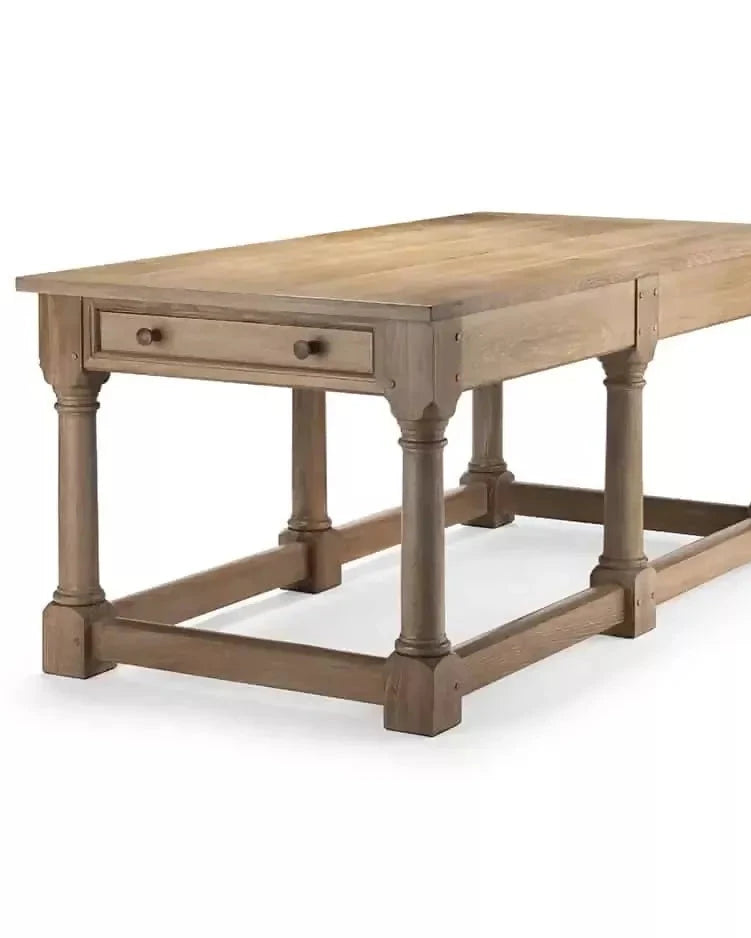 A rectangular wooden refectory table with a drawer at each end and columnar supports, designed in a natural brown finish,  available  to buy on the-salon.com. SALON curates the finest , unique, handmade pieces from the interior industry's best makers and brands. Shop luxury furniture, lighting, rugs, art, antiques and vintage pieces and accessories from SALON interior designed rooms.