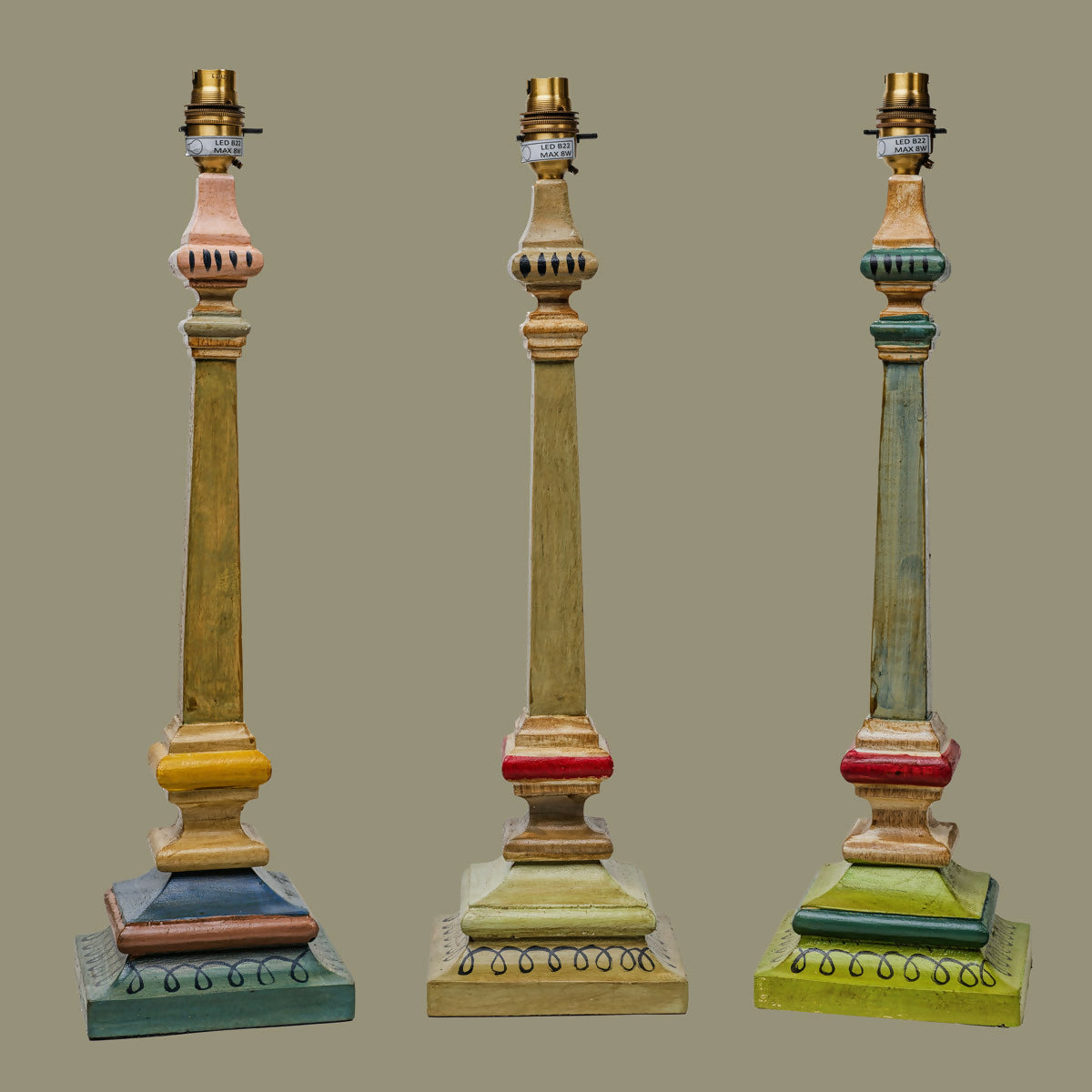 Three decorative lamps with multicolored bases and gold accents on a gray background,  available  to buy on the-salon.com. SALON curates the finest , unique, handmade pieces from the interior industry's best makers and brands. Shop luxury furniture, lighting, rugs, art, antiques and vintage pieces and accessories from SALON interior designed rooms.