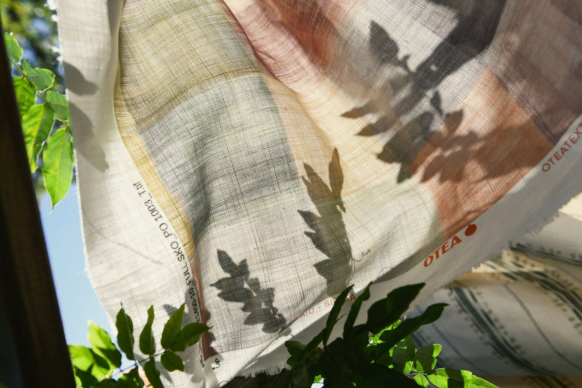 A close-up of a plaid fabric featuring a pattern of various solid colors, including blue, pink, green, and yellow,  available  to buy on the-salon.com. SALON curates the finest , unique, handmade pieces from the interior industry's best makers and brands. Shop luxury furniture, lighting, rugs, art, antiques and vintage pieces and accessories from SALON interior designed rooms.