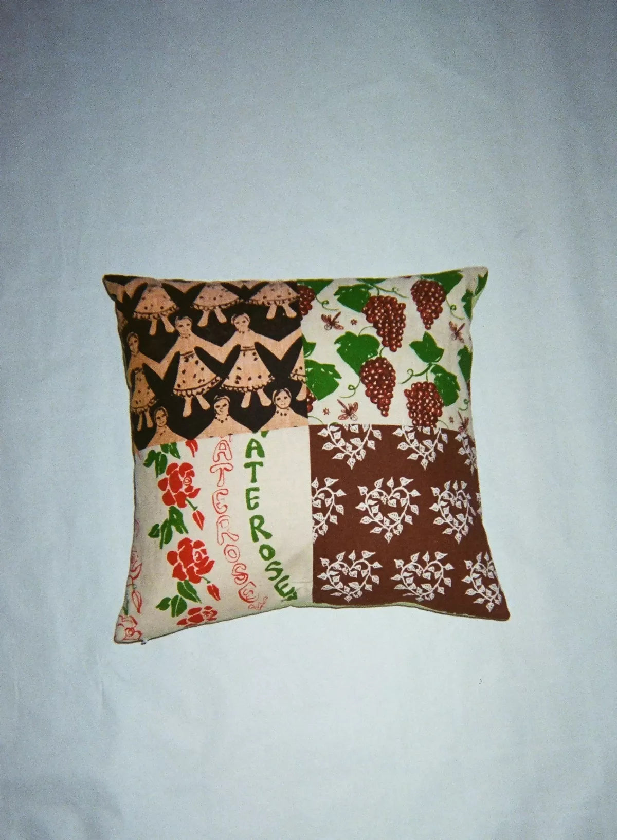 A square patchwork cushion with four different screen printed designs, featuring floral and geometric patterns,  available  to buy on the-salon.com. SALON curates the finest , unique, handmade pieces from the interior industry's best makers and brands. Shop luxury furniture, lighting, rugs, art, antiques and vintage pieces and accessories from SALON interior designed rooms.