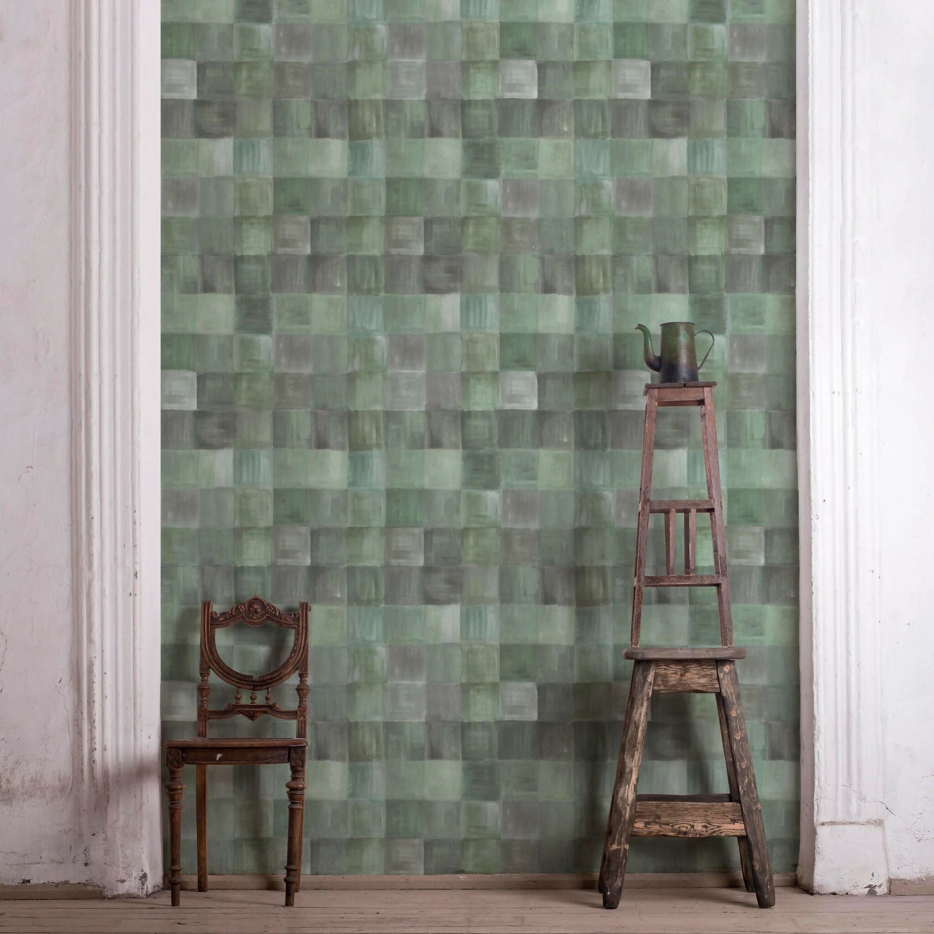 Green mosaic wall tile pattern with a wooden chair and ladder in front,  available  to buy on the-salon.com. SALON curates the finest , unique, handmade pieces from the interior industry's best makers and brands. Shop luxury furniture, lighting, rugs, art, antiques and vintage pieces and accessories from SALON interior designed rooms.