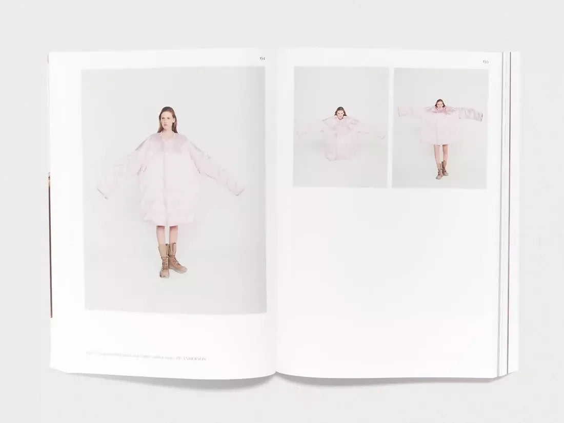 An image of an open book, the pages containing three images, all of the same woman wearing a large white coat, just with different poses infront of a white backdrop,  available  to buy on the-salon.com. SALON curates the finest , unique, handmade pieces from the interior industry's best makers and brands. Shop luxury furniture, lighting, rugs, art, antiques and vintage pieces and accessories from SALON interior designed rooms.