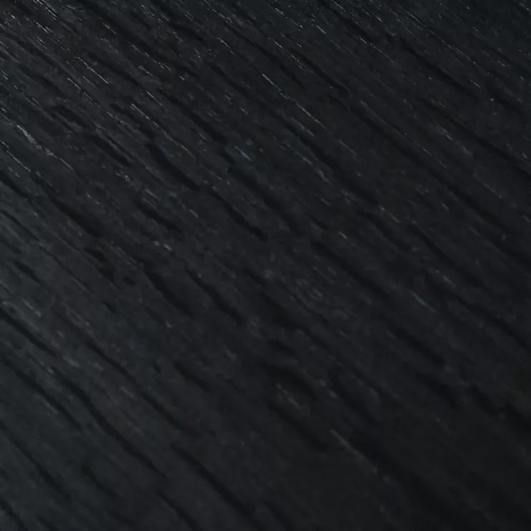 A close up of the ebonised wood, showing it to be black wood, still with wood grains visible,  available  to buy on the-salon.com. SALON curates the finest , unique, handmade pieces from the interior industry's best makers and brands. Shop luxury furniture, lighting, rugs, art, antiques and vintage pieces and accessories from SALON interior designed rooms.