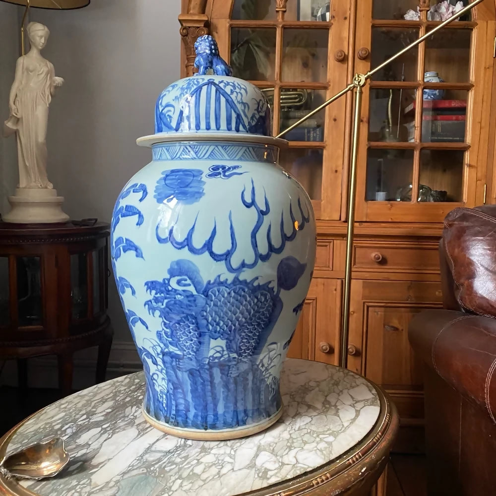 Blue and white decorative vase on a marble table with wooden cabinet in the background,available to buy from the-salon.com. SALON curates the finest unique handmade pieces from the interior industry's best makers and brands. Shop luxury furniture, lighting, rugs, art, antiques and vintage pieces and accessories from SALON interior designed rooms.