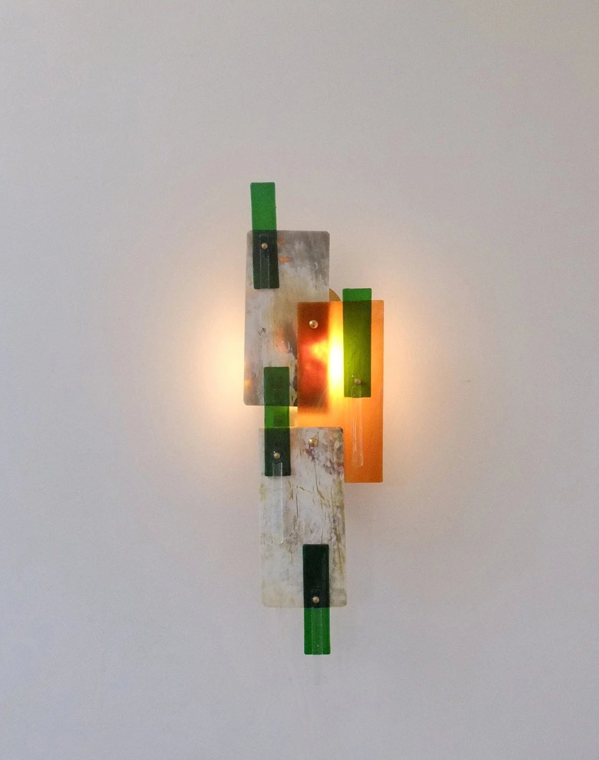Modern wall sconce with geometric design on a white wall