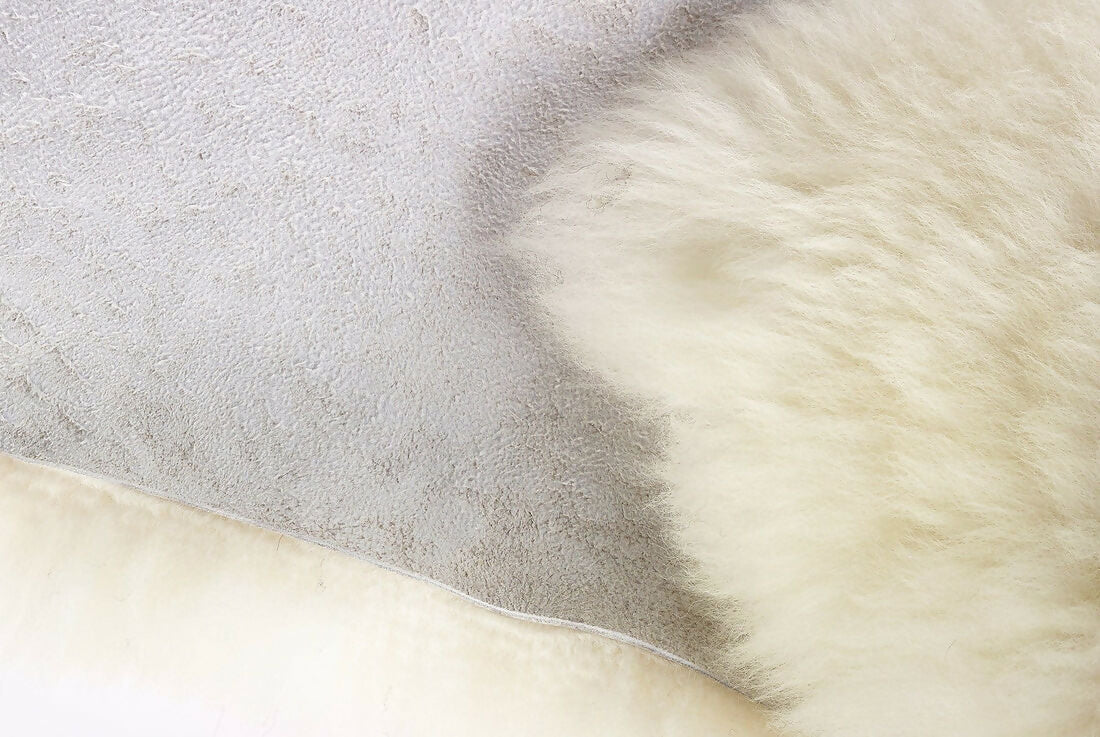 Close up of a white  sheepskin rug. The rug, available to buy from the-salon.com. SALON curates the finest unique handmade pieces from the interior industry's best makers and brands. Shop luxury furniture, lighting, rugs, art, antiques and vintage pieces and accessories from SALON interior designed rooms.