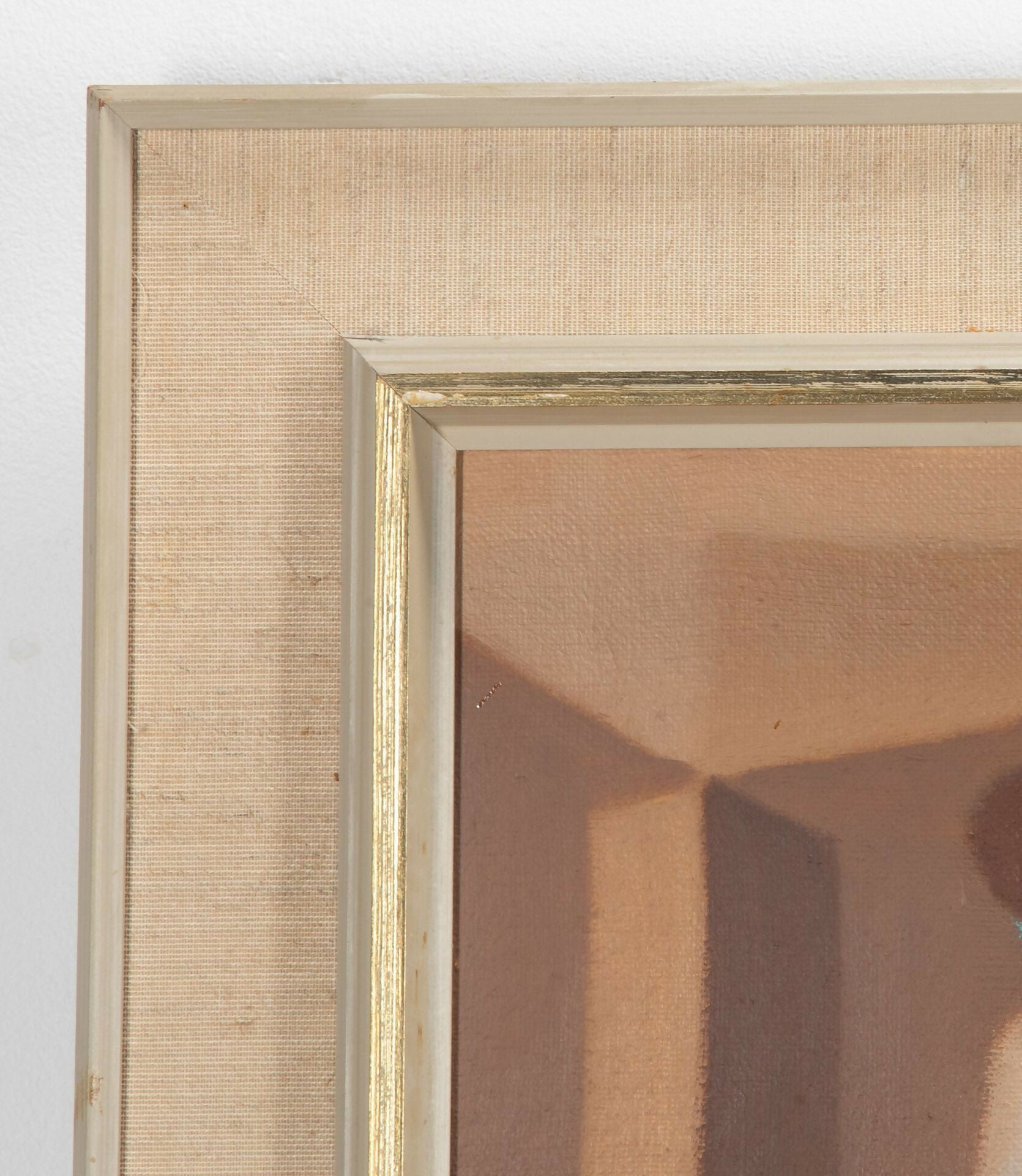 Close-up of a gold-framed painting with a textured wall background,  available  to buy on the-salon.com. SALON curates the finest , unique, handmade pieces from the interior industry's best makers and brands. Shop luxury furniture, lighting, rugs, art, antiques and vintage pieces and accessories from SALON interior designed rooms.