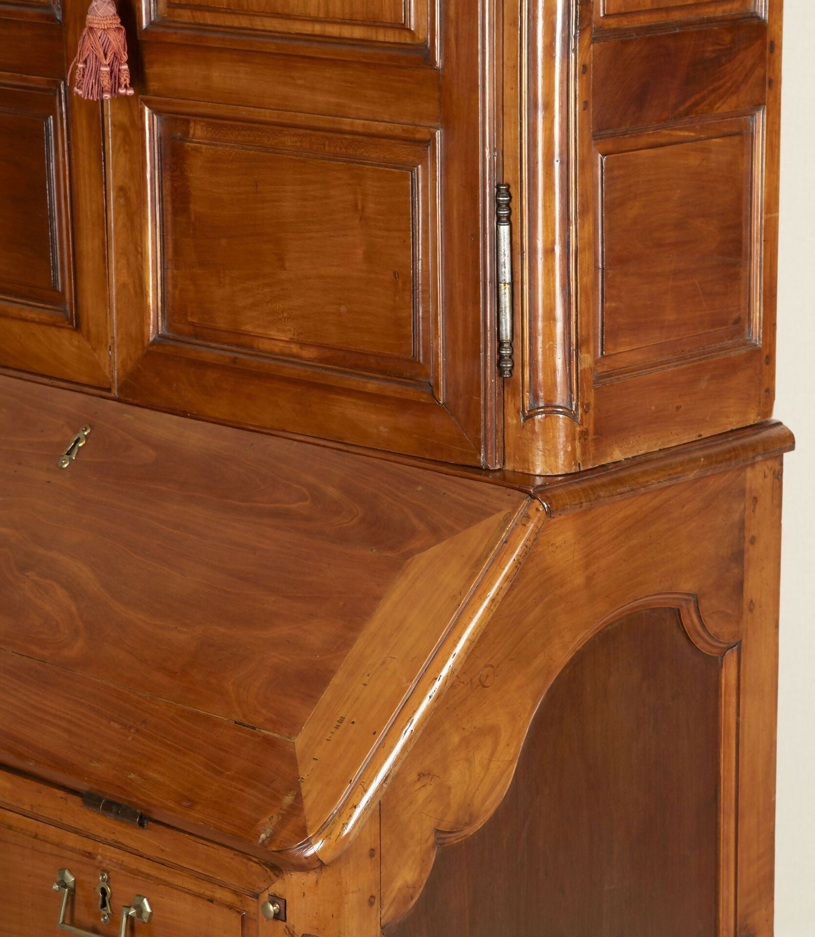 Close-up of a wooden cabinet with a hand on one of the doors,  available  to buy on the-salon.com. SALON curates the finest , unique, handmade pieces from the interior industry's best makers and brands. Shop luxury furniture, lighting, rugs, art, antiques and vintage pieces and accessories from SALON interior designed rooms.