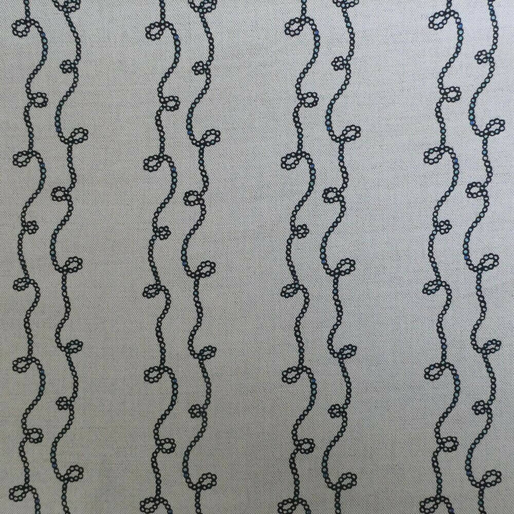 A swatch of fabric featuring a white  background with a blue geometric pattern consisting of twisted shapes,  available  to buy on the-salon.com. SALON curates the finest , unique, handmade pieces from the interior industry's best makers and brands. Shop luxury furniture, lighting, rugs, art, antiques and vintage pieces and accessories from SALON interior designed rooms.