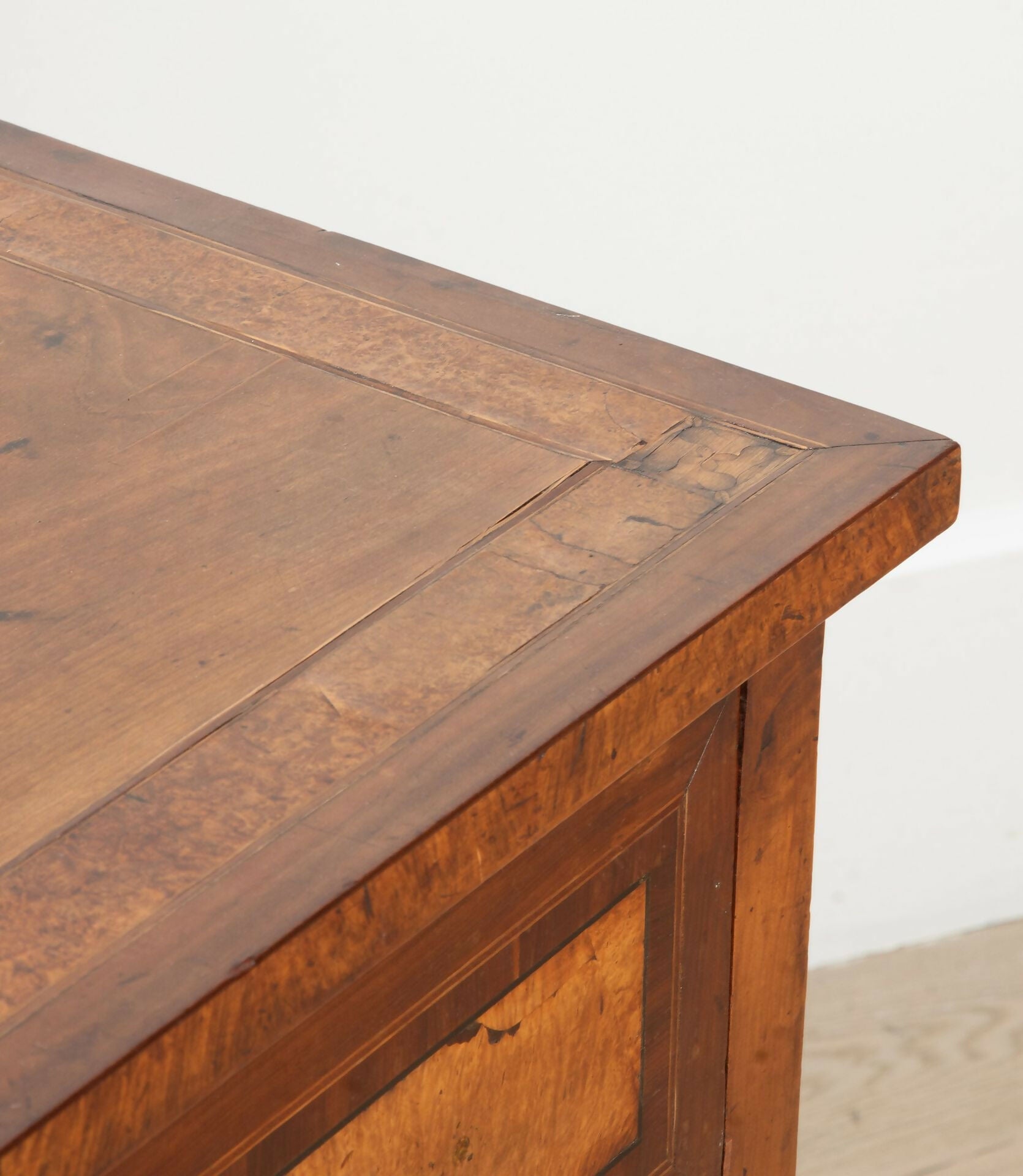 Close-up of a wooden desk corner with a plain background,  available  to buy on the-salon.com. SALON curates the finest , unique, handmade pieces from the interior industry's best makers and brands. Shop luxury furniture, lighting, rugs, art, antiques and vintage pieces and accessories from SALON interior designed rooms.