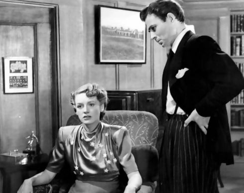 A black and white image of two people in a room, with a woman sitting and a man standing, likely representing characters from the novel,  available  to buy on the-salon.com. SALON curates the finest , unique, handmade pieces from the interior industry's best makers and brands. Shop luxury furniture, lighting, rugs, art, antiques and vintage pieces and accessories from SALON interior designed rooms.