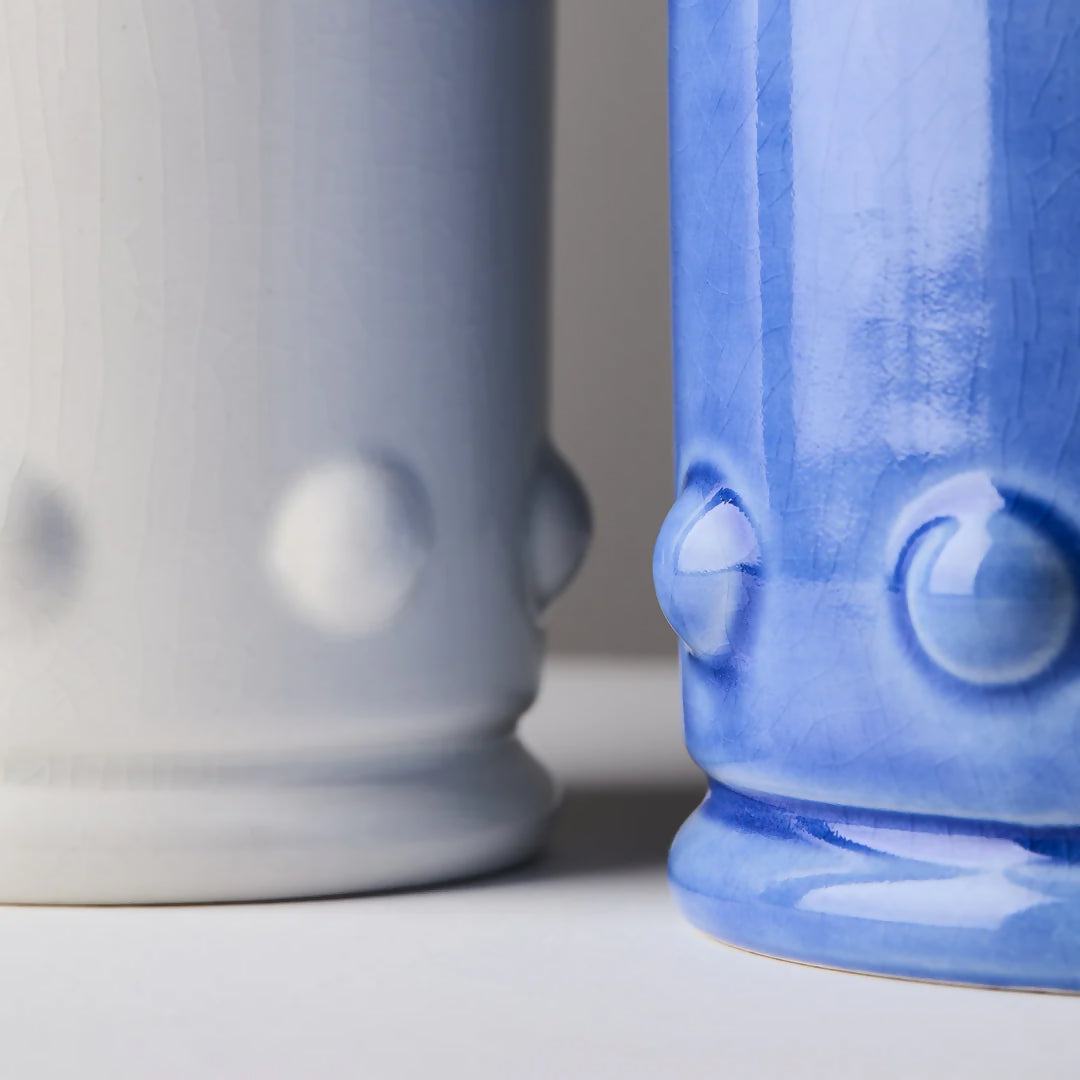 Close up of the detailing along the sides of the blue and white candles,  available  to buy on the-salon.com. SALON curates the finest , unique, handmade pieces from the interior industry's best makers and brands. Shop luxury furniture, lighting, rugs, art, antiques and vintage pieces and accessories from SALON interior designed rooms.