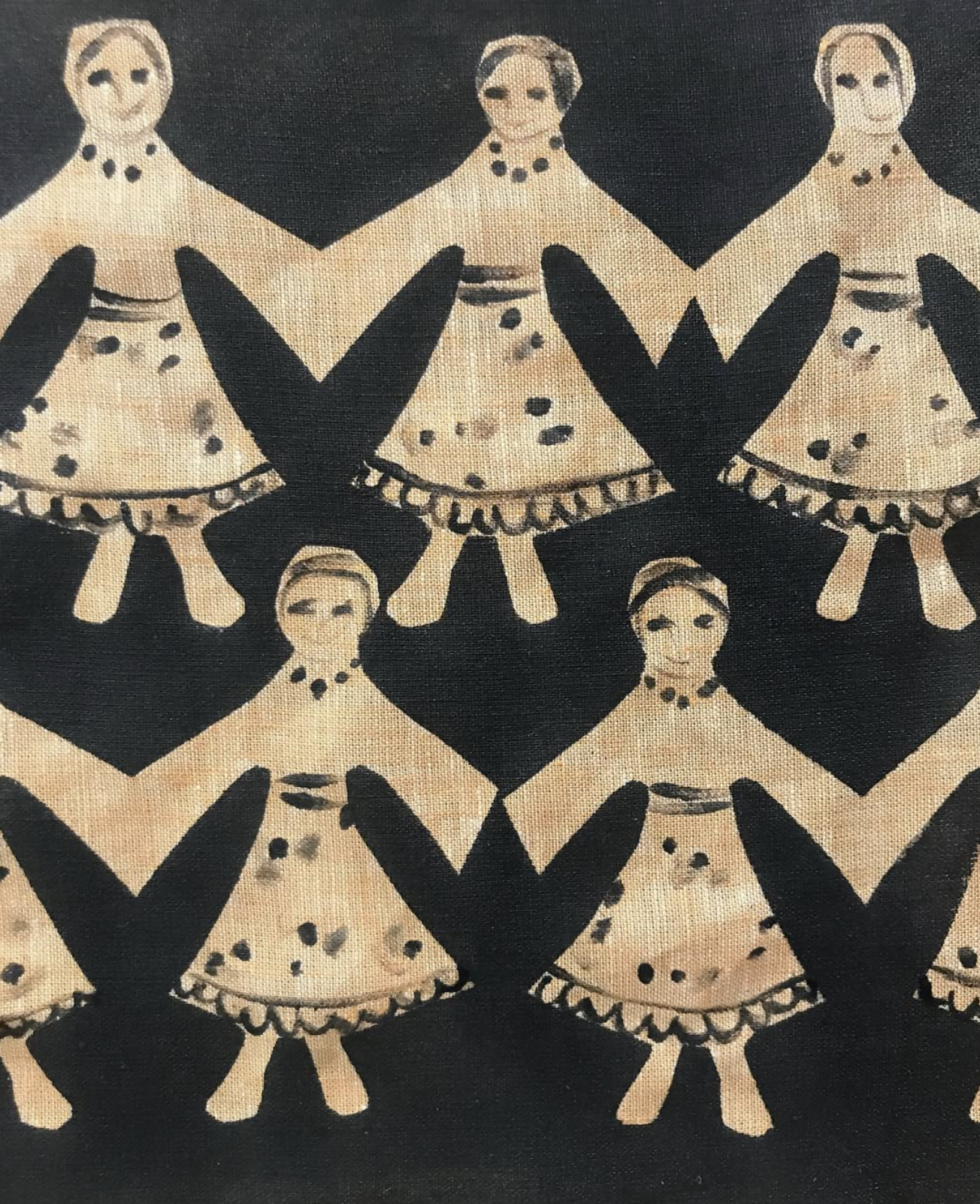 A patterned fabric featuring stylized figures with traditional Polish folk art influences, predominantly in black and a beige or light color, available  to buy on the-salon.com. SALON curates the finest , unique, handmade pieces from the interior industry's best makers and brands. Shop luxury furniture, lighting, rugs, art, antiques and vintage pieces and accessories from SALON interior designed rooms.