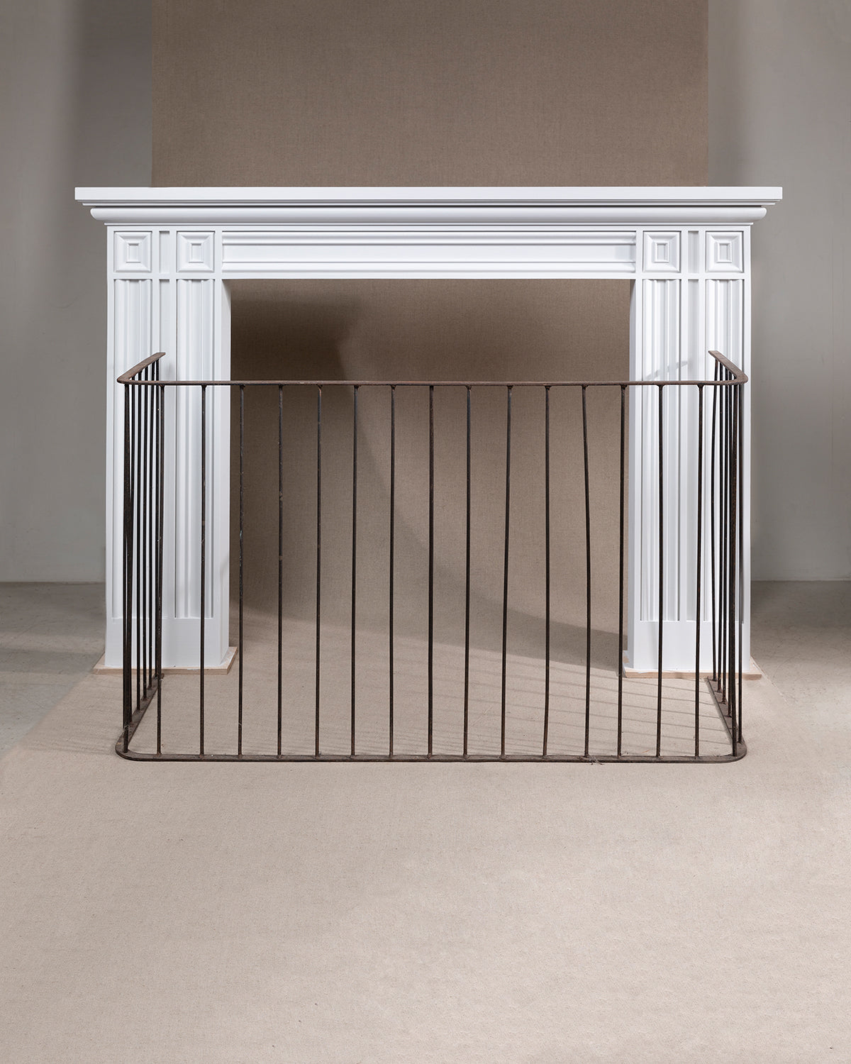 An image of a white fireplace standing alone against a beige background,  available  to buy on the-salon.com. SALON curates the finest , unique, handmade pieces from the interior industry's best makers and brands. Shop luxury furniture, lighting, rugs, art, antiques and vintage pieces and accessories from SALON interior designed rooms.