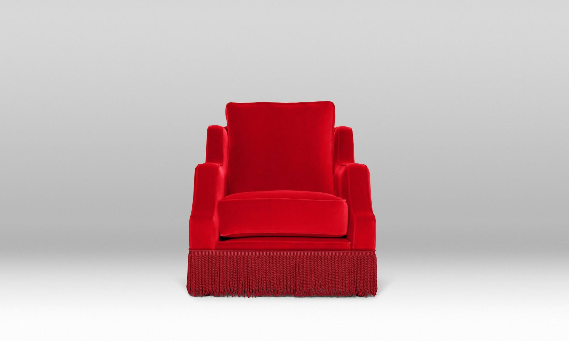 An ornate upholstered Atlanta chair with velvet fabric and tasseled fringe, designed by Orior, available  to buy on the-salon.com. SALON curates the finest , unique, handmade pieces from the interior industry's best makers and brands. Shop luxury furniture, lighting, rugs, art, antiques and vintage pieces and accessories from SALON interior designed rooms.