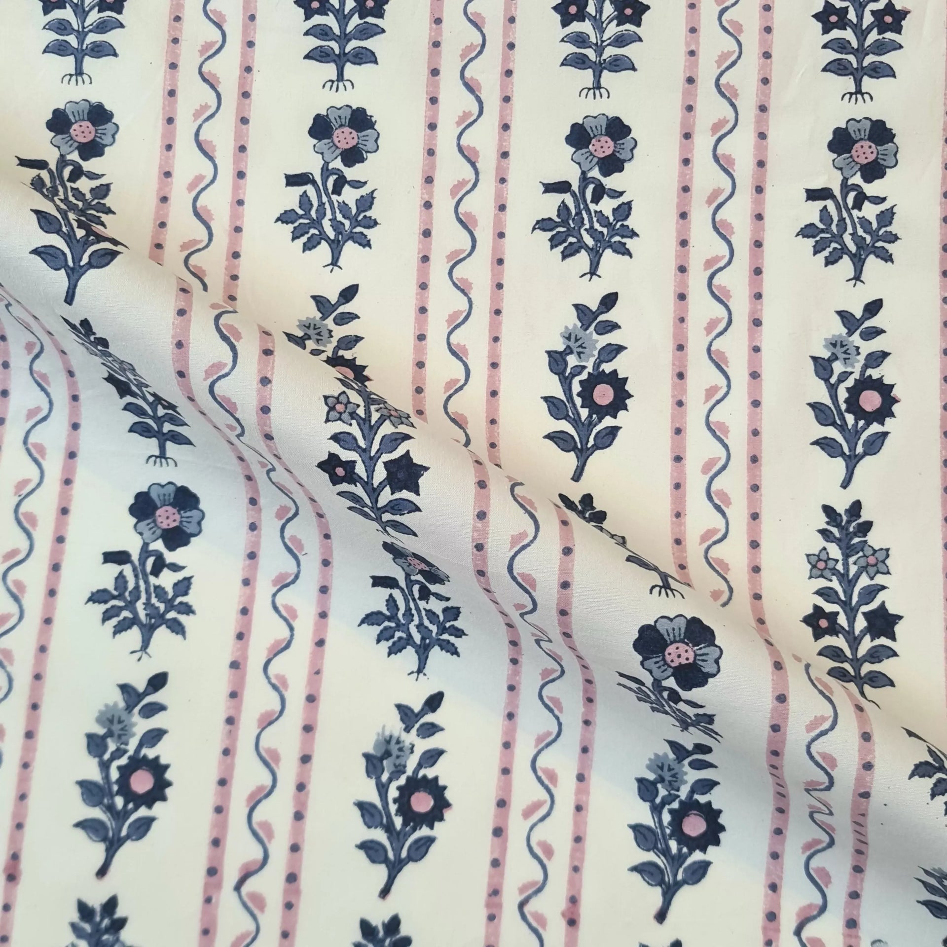 Fabric with floral and striped pattern on a beige background,  available  to buy on the-salon.com. SALON curates the finest , unique, handmade pieces from the interior industry's best makers and brands. Shop luxury furniture, lighting, rugs, art, antiques and vintage pieces and accessories from SALON interior designed rooms.