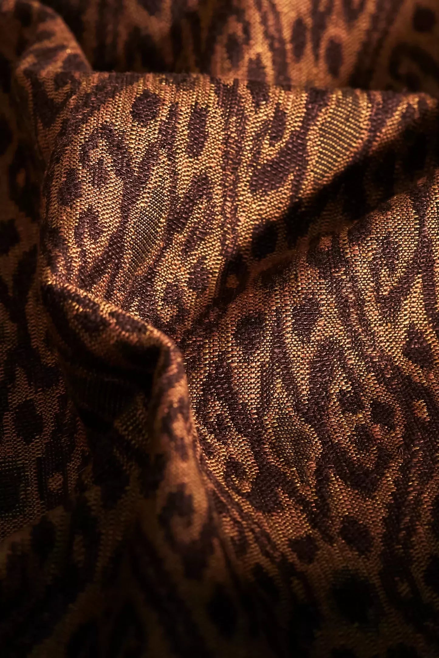 A fabric with a woven ikat pattern, featuring a geometric design in a tiger's eye colour,  available  to buy on the-salon.com. SALON curates the finest , unique, handmade pieces from the interior industry's best makers and brands. Shop luxury furniture, lighting, rugs, art, antiques and vintage pieces and accessories from SALON interior designed rooms.