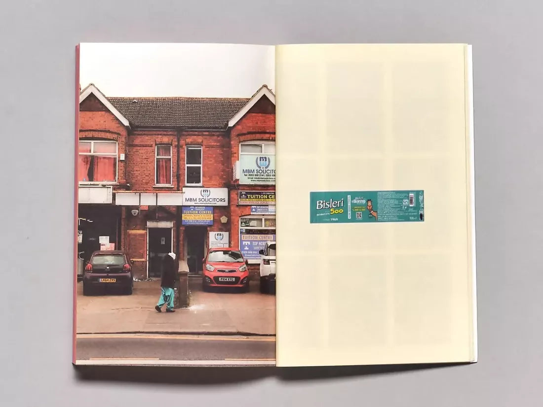 An open book, the pages to one side outside a solicitors office on an average road in the UK, the other side being a wrapper for a water bottle, available  to buy on the-salon.com. SALON curates the finest , unique, handmade pieces from the interior industry's best makers and brands. Shop luxury furniture, lighting, rugs, art, antiques and vintage pieces and accessories from SALON interior designed rooms.