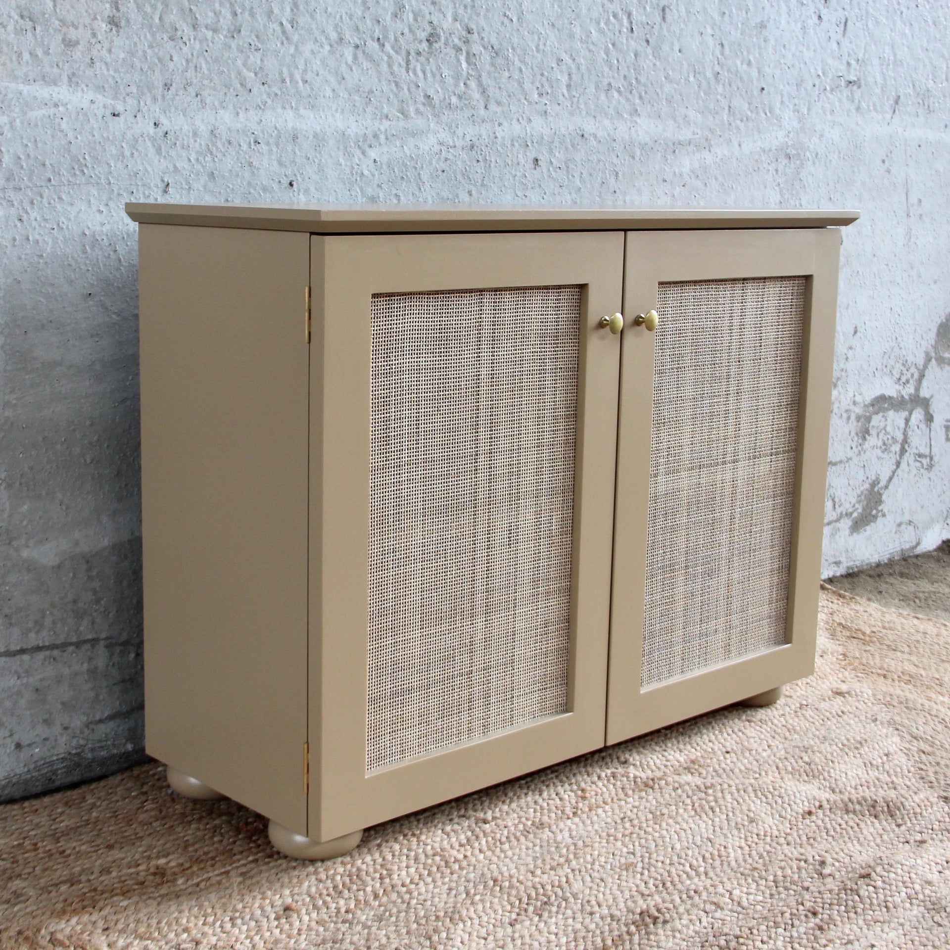 CANED CABINET BY ALFRED NEWALL