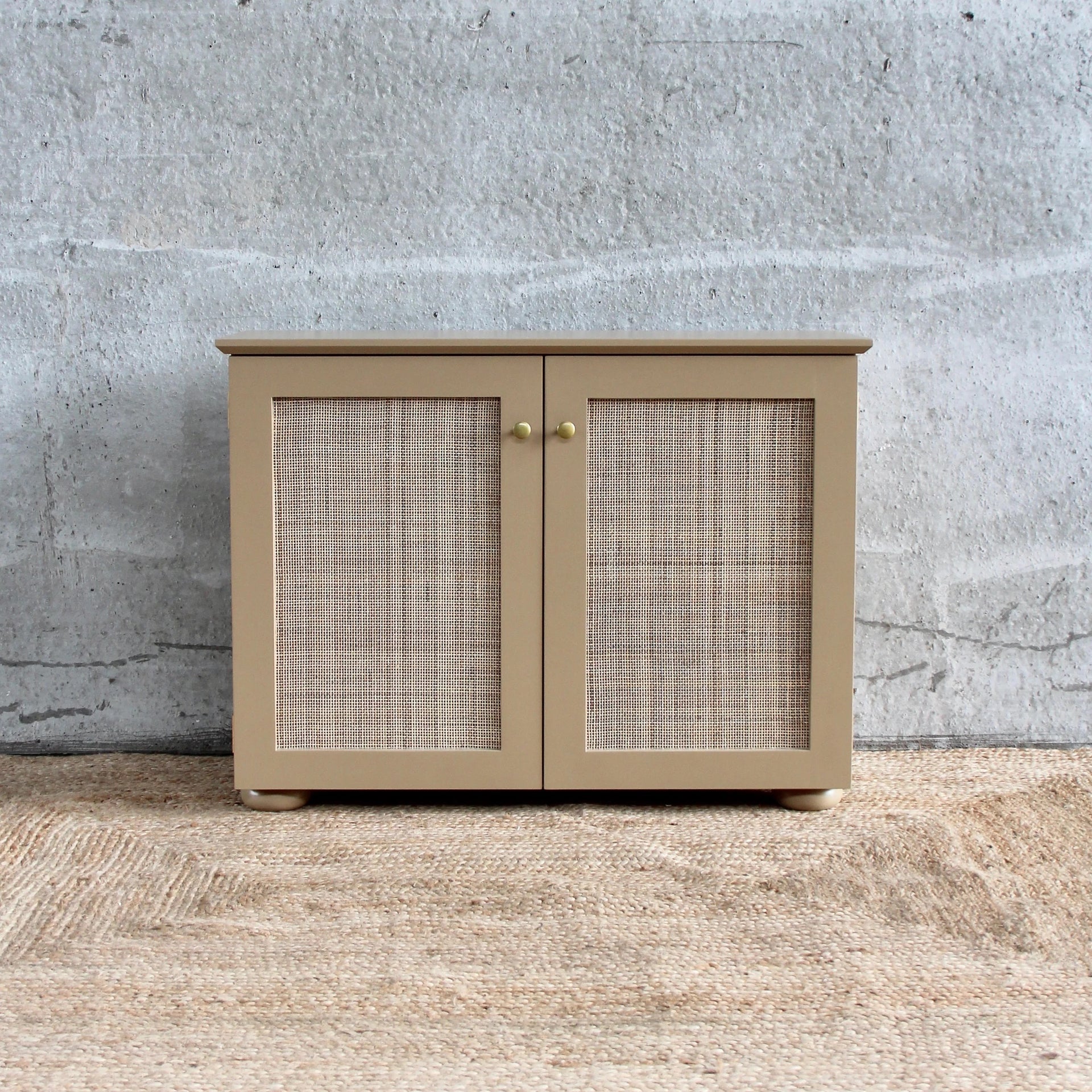 CANED CABINET BY ALFRED NEWALL