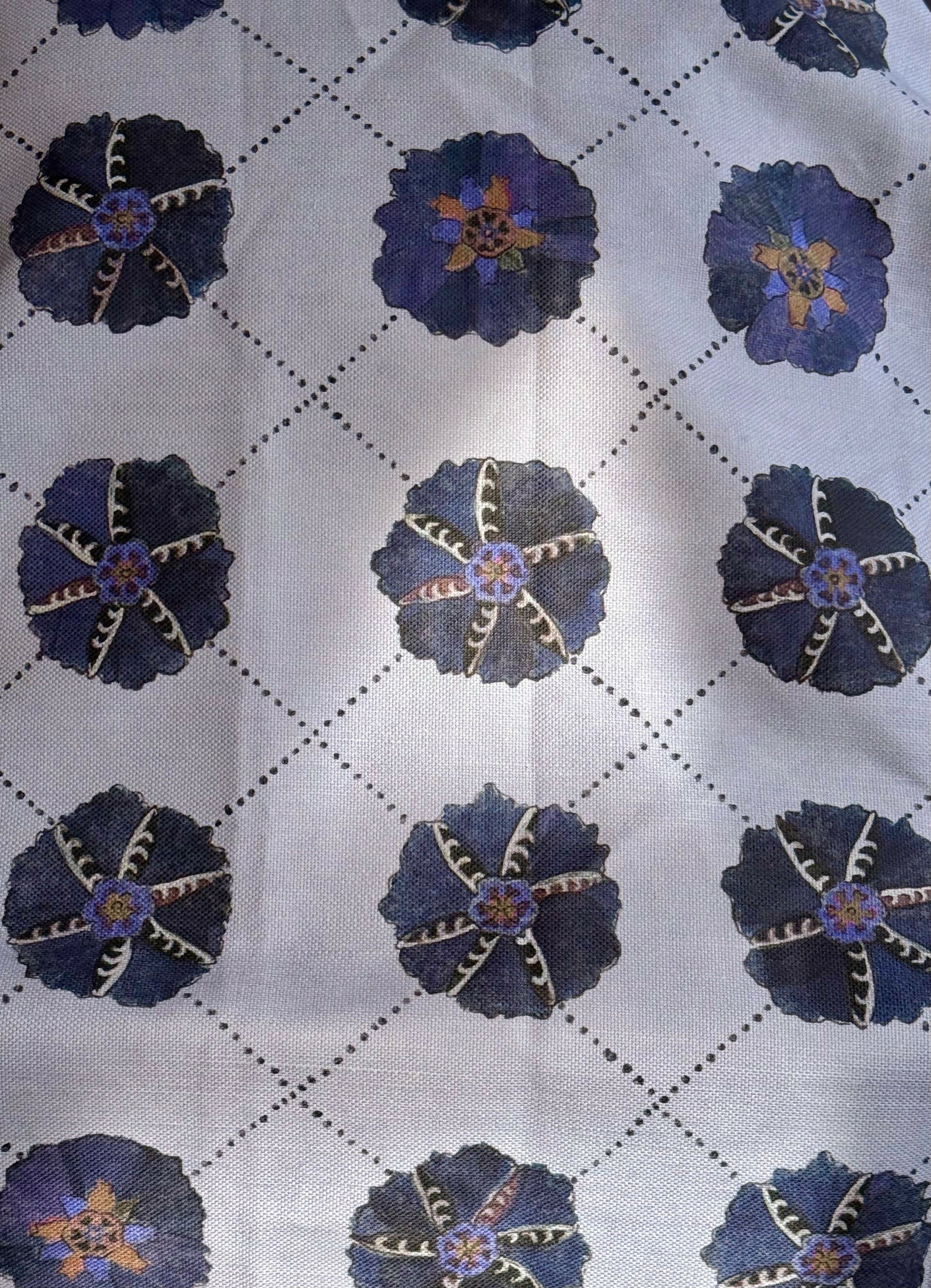 A piece of suzani fabric with floral patterns in purples, blues and multicolor hues,  available  to buy on the-salon.com. SALON curates the finest , unique, handmade pieces from the interior industry's best makers and brands. Shop luxury furniture, lighting, rugs, art, antiques and vintage pieces and accessories from SALON interior designed rooms.