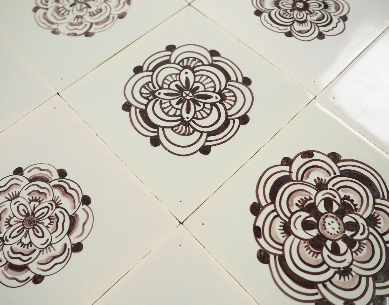 Floral mandala designs on white tiles,  available  to buy on the-salon.com. SALON curates the finest , unique, handmade pieces from the interior industry's best makers and brands. Shop luxury furniture, lighting, rugs, art, antiques and vintage pieces and accessories from SALON interior designed rooms.