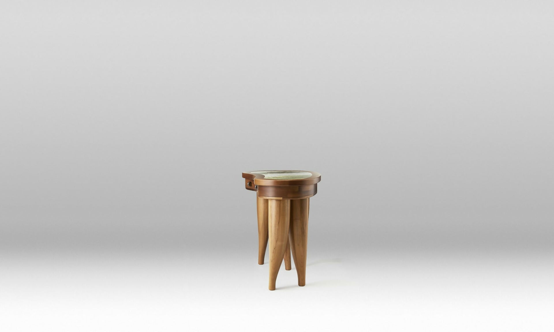 A wooden desk with a curved, organic shape and solid wood legs, featuring a marble top with brass hardware and leather inlay drawers,  available  to buy on the-salon.com. SALON curates the finest , unique, handmade pieces from the interior industry's best makers and brands. Shop luxury furniture, lighting, rugs, art, antiques and vintage pieces and accessories from SALON interior designed rooms.