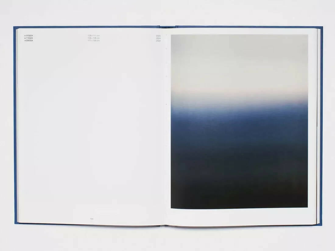 An image of an open book containing a blank page and a picture of a gradient from white to blue and then dark tones,  available  to buy on the-salon.com. SALON curates the finest , unique, handmade pieces from the interior industry's best makers and brands. Shop luxury furniture, lighting, rugs, art, antiques and vintage pieces and accessories from SALON interior designed rooms.