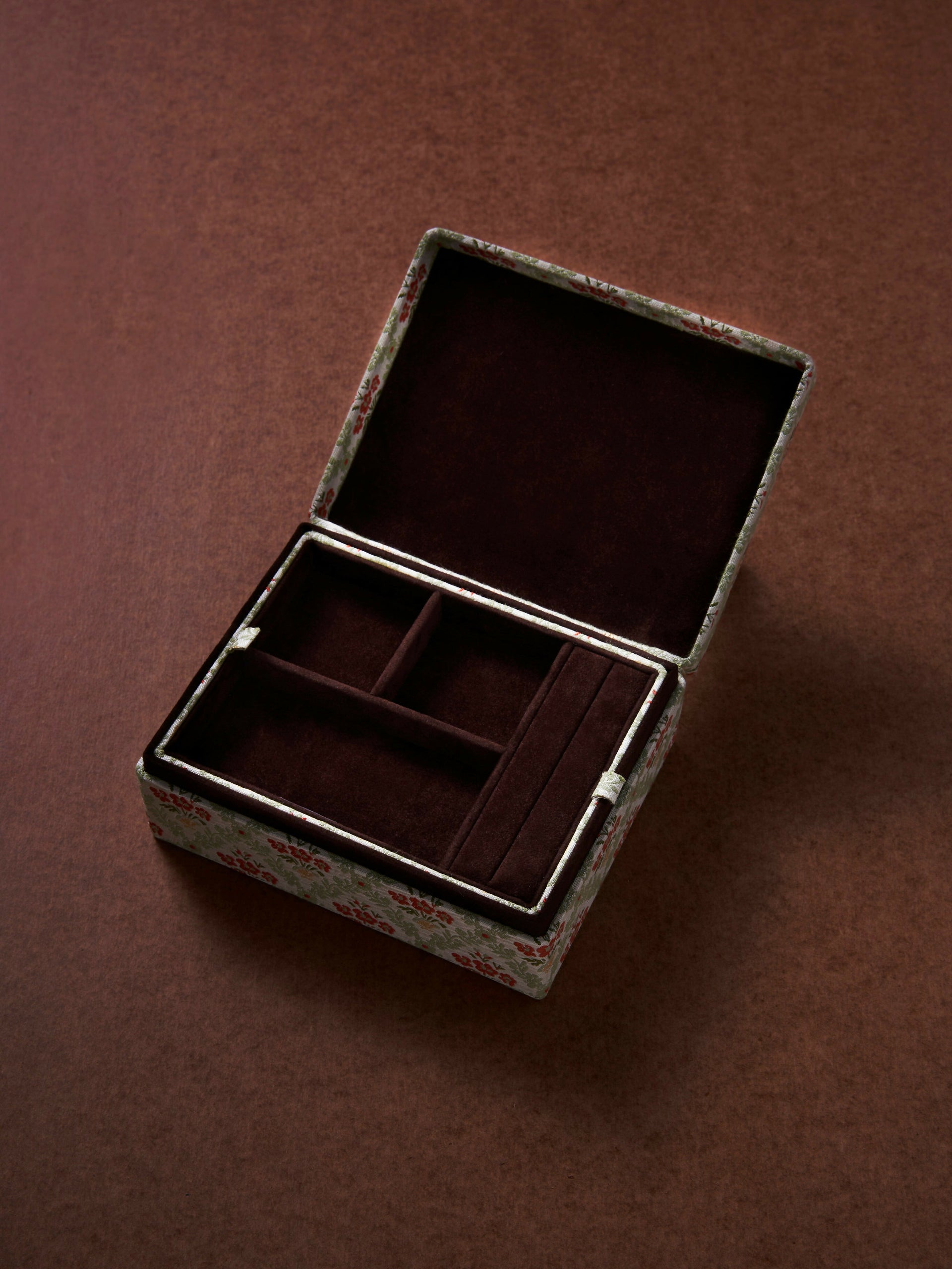 Open jewelry box with compartments on a brown background,  available  to buy on the-salon.com. SALON curates the finest , unique, handmade pieces from the interior industry's best makers and brands. Shop luxury furniture, lighting, rugs, art, antiques and vintage pieces and accessories from SALON interior designed rooms.