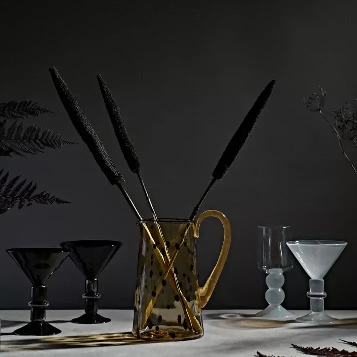 Gold, clear jug in a dark background,  available  to buy on the-salon.com. SALON curates the finest , unique, handmade pieces from the interior industry's best makers and brands. Shop luxury furniture, lighting, rugs, art, antiques and vintage pieces and accessories from SALON interior designed rooms.