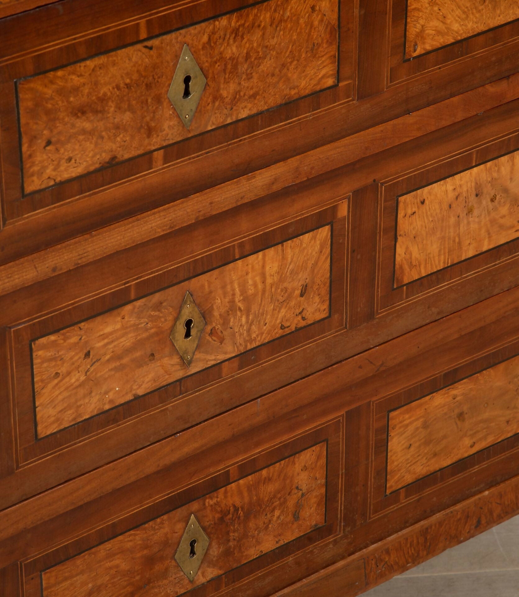 Close-up of a wooden dresser with visible grain and keyhole details,  available  to buy on the-salon.com. SALON curates the finest , unique, handmade pieces from the interior industry's best makers and brands. Shop luxury furniture, lighting, rugs, art, antiques and vintage pieces and accessories from SALON interior designed rooms.